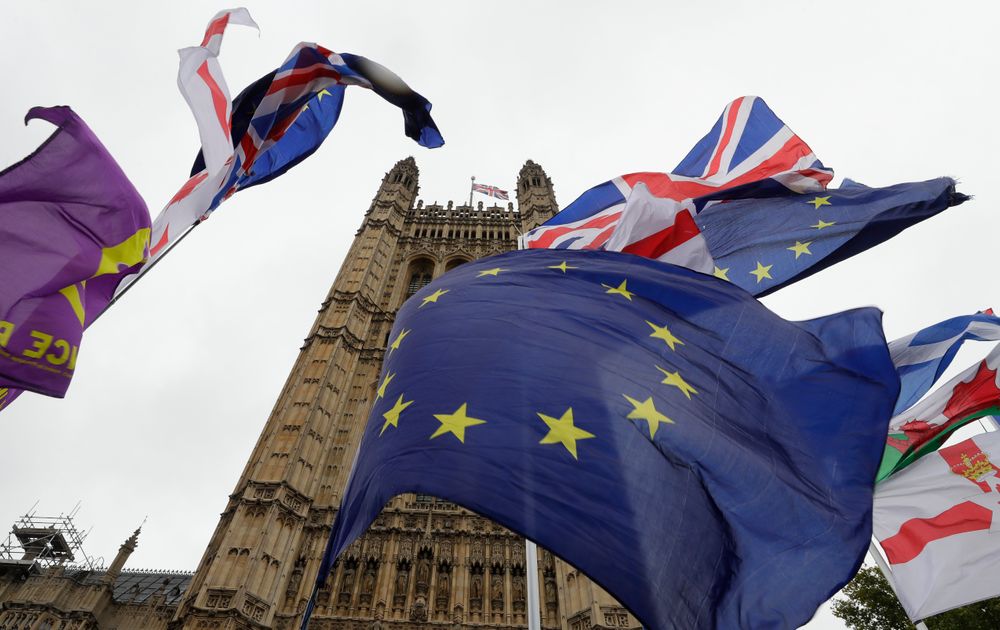A confusion of various flags fly outside Parliament in London, Monday, Oct. 21, 2019. The European Commission says the fact that British Prime Minister Boris Johnson did not sign a letter requesting a three-month extension of the Brexit deadline has no impact on whether it is valid and that the European Union is considering the request. (AP Photo/Kirsty Wigglesworth) A confusion of various flags fly outside Parliament in London, Monday, Oct. 21, 2019. The European Commission says the fact that British Prime Minister Boris Johnson did not sign a letter requesting a three-month extension of the Brexit deadline has no impact on whether it is valid and that the European Union is considering the request. (AP Photo/Kirsty Wigglesworth)