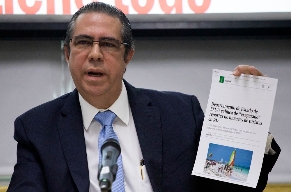 The Minister of Tourism of the Dominican Republic Francisco Javier García, holds a copy of an online article in a local paper saying the U.S. State Department considers recent reports on tourists' deaths to be exaggerated, at the Ministry of Tourism office in Santo Domingo, Dominican Republic, Friday, June 21, 2019. According to García the deaths of eight American tourists in the Dominican Republic this year are not part of a mysterious cluster but rather a medically and statistically normal phenomenon that has been irresponsibly lumped together by the U.S. media. (AP Photo/Tatiana Fernandez) The Minister of Tourism of the Dominican Republic Francisco Javier García, holds a copy of an online article in a local paper saying the U.S. State Department considers recent reports on tourists' deaths to be exaggerated, at the Ministry of Tourism office in Santo Domingo, Dominican Republic, Friday, June 21, 2019. According to García the deaths of eight American tourists in the Dominican Republic this year are not part of a mysterious cluster but rather a medically and statistically normal phenomenon that has been irresponsibly lumped together by the U.S. media. (AP Photo/Tatiana Fernandez)