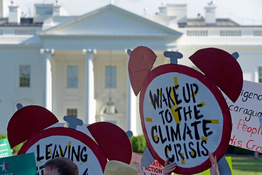 FILE- In this June 1, 2017 file photo, protesters gather outside the White House in Washington to protest President Donald Trump's decision to withdraw the Unites States from the Paris climate change accord. For more than two years President Trump has talked about pulling the United States out of the landmark Paris climate agreement. Starting Monday, he can finally do something about it. But the withdrawal process will take a year and doesn’t become official until the day after the 2020 presidential election. And if someone other than Trump wins in 2020, the next president can get back in the deal in just 30 days. (AP Photo/Susan Walsh) FILE- In this June 1, 2017 file photo, protesters gather outside the White House in Washington to protest President Donald Trump's decision to withdraw the Unites States from the Paris climate change accord. For more than two years President Trump has talked about pulling the United States out of the landmark Paris climate agreement. Starting Monday, he can finally do something about it. But the withdrawal process will take a year and doesn’t become official until the day after the 2020 presidential election. And if someone other than Trump wins in 2020, the next president can get back in the deal in just 30 days. (AP Photo/Susan Walsh)