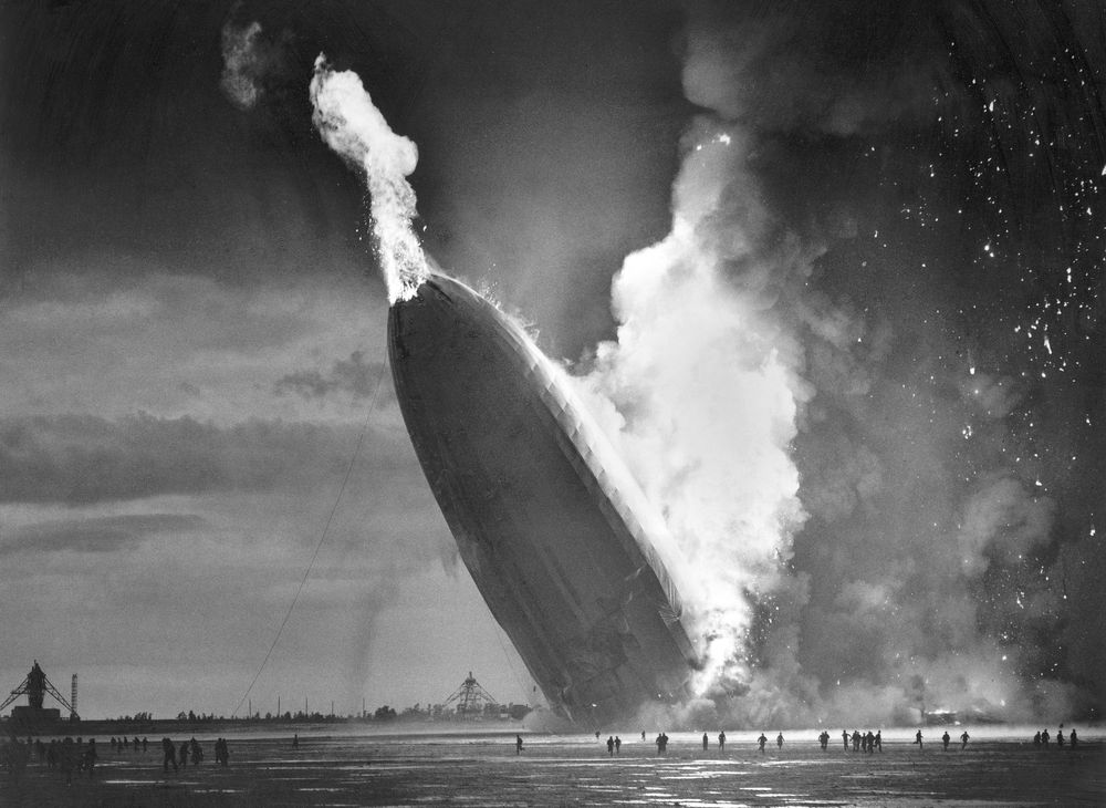 FILE - In this May 6, 1937 file photo, the German dirigible Hindenburg crashes to earth in flames after exploding at the U.S. Naval Station in Lakehurst, N.J. Werner Gustav Doehner, the last survivor of the disaster, died Nov. 8, 2019 at age 90 in Laconia, N.H. Doehner was 8-years old when he boarded the zeppelin in Germany with his parents and older siblings to return from a vacation. (AP Photo/Murray Becker, File) FILE - In this May 6, 1937 file photo, the German dirigible Hindenburg crashes to earth in flames after exploding at the U.S. Naval Station in Lakehurst, N.J. Werner Gustav Doehner, the last survivor of the disaster, died Nov. 8, 2019 at age 90 in Laconia, N.H. Doehner was 8-years old when he boarded the zeppelin in Germany with his parents and older siblings to return from a vacation. (AP Photo/Murray Becker, File)