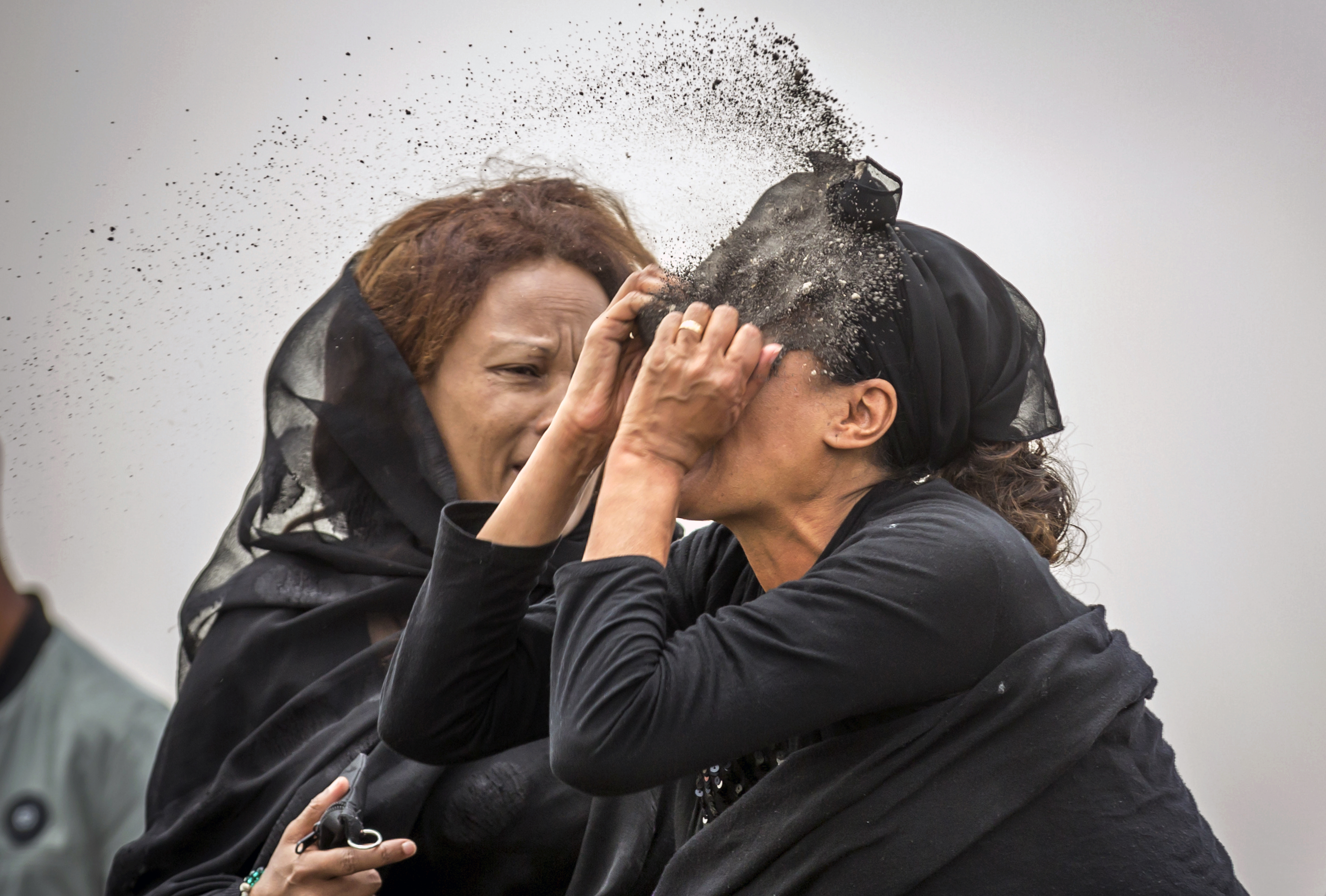An Ethiopian relative of a crash victim throws dirt in her own face after realising that there is nothing physical left of her loved one, as she mourns at the scene where the Ethiopian Airlines Boeing 737 Max 8 crashed shortly after takeoff on Sunday killing all 157 on board, near Bishoftu, south-east of Addis Ababa, in Ethiopia Thursday, March 14, 2019. About 200 family members of people who died on the crashed jet stormed out of a briefing with Ethiopian Airlines officials in Addis Ababa on Thursday, complaining that the airline has not given them adequate information. (AP Photo/Mulugeta Ayene) An Ethiopian relative of a crash victim throws dirt in her own face after realising that there is nothing physical left of her loved one, as she mourns at the scene where the Ethiopian Airlines Boeing 737 Max 8 crashed shortly after takeoff on Sunday killing all 157 on board, near Bishoftu, south-east of Addis Ababa, in Ethiopia Thursday, March 14, 2019. About 200 family members of people who died on the crashed jet stormed out of a briefing with Ethiopian Airlines officials in Addis Ababa on Thursday, complaining that the airline has not given them adequate information. (AP Photo/Mulugeta Ayene)