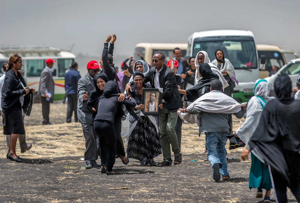 Ethiopian relatives of crash victims mourn at the scene where the Ethiopian Airlines Boeing 737 Max 8 crashed shortly after takeoff on Sunday killing all 157 on board, near Bishoftu, south-east of Addis Ababa, in Ethiopia Thursday, March 14, 2019. About 200 family members of people who died on the crashed jet stormed out of a briefing with Ethiopian Airlines officials in Addis Ababa on Thursday, complaining that the airline has not given them adequate information. (AP Photo/Mulugeta Ayene) Ethiopian relatives of crash victims mourn at the scene where the Ethiopian Airlines Boeing 737 Max 8 crashed shortly after takeoff on Sunday killing all 157 on board, near Bishoftu, south-east of Addis Ababa, in Ethiopia Thursday, March 14, 2019. About 200 family members of people who died on the crashed jet stormed out of a briefing with Ethiopian Airlines officials in Addis Ababa on Thursday, complaining that the airline has not given them adequate information. (AP Photo/Mulugeta Ayene)