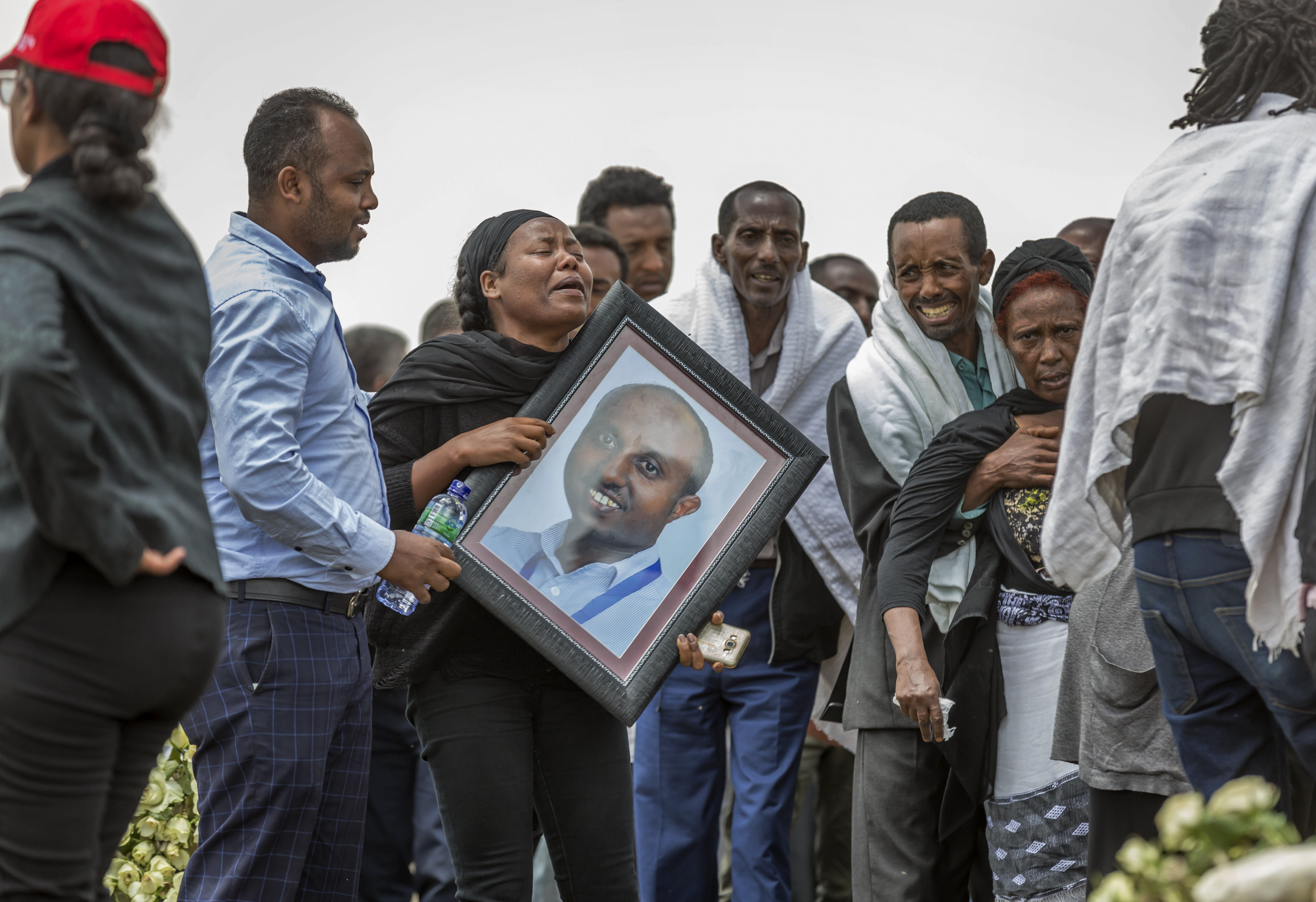 Ethiopian relatives of crash victims mourn and grieve at the scene where the Ethiopian Airlines Boeing 737 Max 8 crashed shortly after takeoff on Sunday killing all 157 on board, near Bishoftu, south-east of Addis Ababa, in Ethiopia Thursday, March 14, 2019. About 200 family members of people who died on the crashed jet stormed out of a briefing with Ethiopian Airlines officials in Addis Ababa on Thursday, complaining that the airline has not given them adequate information. (AP Photo/Mulugeta Ayene) Ethiopian relatives of crash victims mourn and grieve at the scene where the Ethiopian Airlines Boeing 737 Max 8 crashed shortly after takeoff on Sunday killing all 157 on board, near Bishoftu, south-east of Addis Ababa, in Ethiopia Thursday, March 14, 2019. About 200 family members of people who died on the crashed jet stormed out of a briefing with Ethiopian Airlines officials in Addis Ababa on Thursday, complaining that the airline has not given them adequate information. (AP Photo/Mulugeta Ayene)