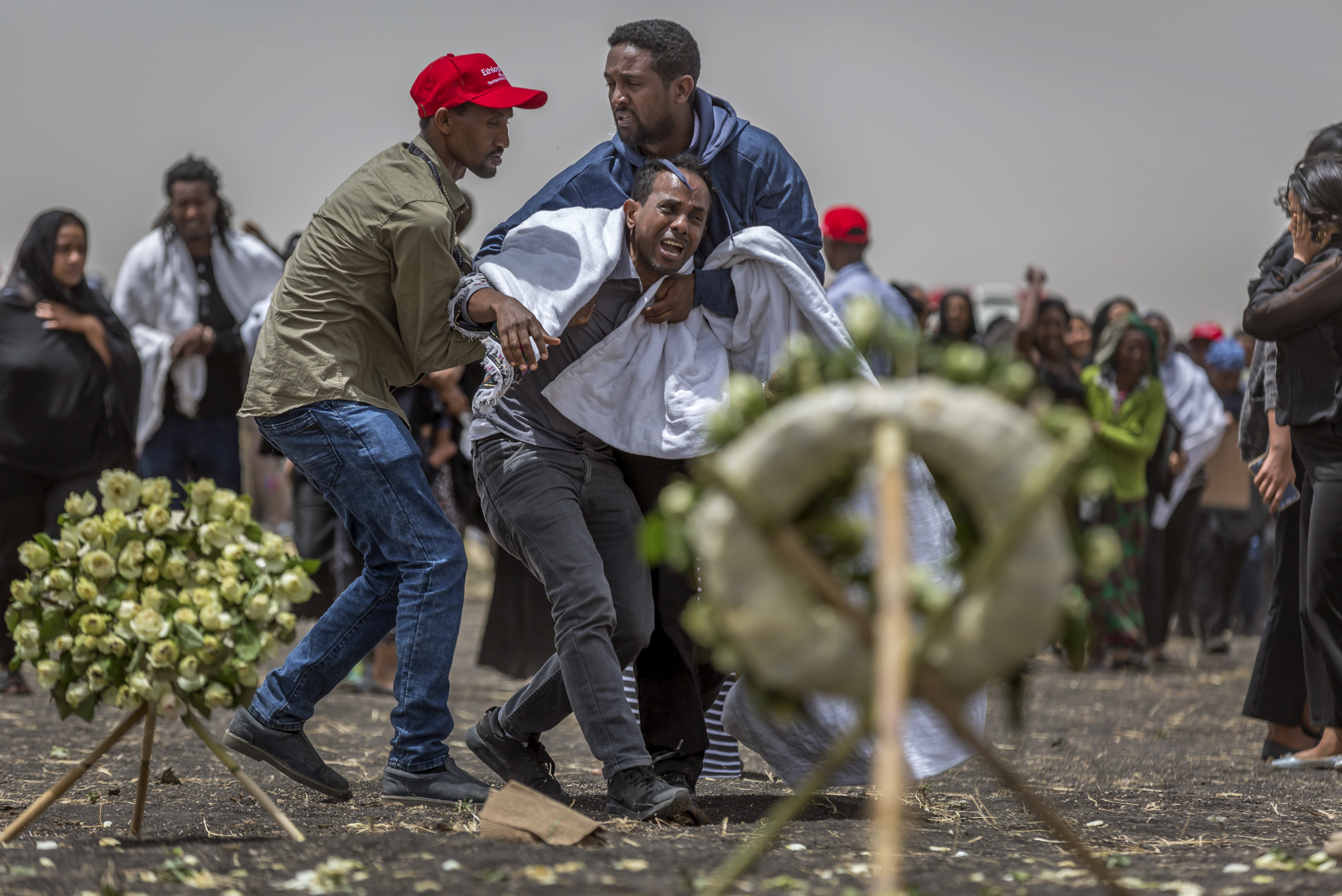 Ethiopian relatives of crash victims mourn and grieve at the scene where the Ethiopian Airlines Boeing 737 Max 8 crashed shortly after takeoff on Sunday killing all 157 on board, near Bishoftu, south-east of Addis Ababa, in Ethiopia Thursday, March 14, 2019. About 200 family members of people who died on the crashed jet stormed out of a briefing with Ethiopian Airlines officials in Addis Ababa on Thursday, complaining that the airline has not given them adequate information. (AP Photo/Mulugeta Ayene) Ethiopian relatives of crash victims mourn and grieve at the scene where the Ethiopian Airlines Boeing 737 Max 8 crashed shortly after takeoff on Sunday killing all 157 on board, near Bishoftu, south-east of Addis Ababa, in Ethiopia Thursday, March 14, 2019. About 200 family members of people who died on the crashed jet stormed out of a briefing with Ethiopian Airlines officials in Addis Ababa on Thursday, complaining that the airline has not given them adequate information. (AP Photo/Mulugeta Ayene)