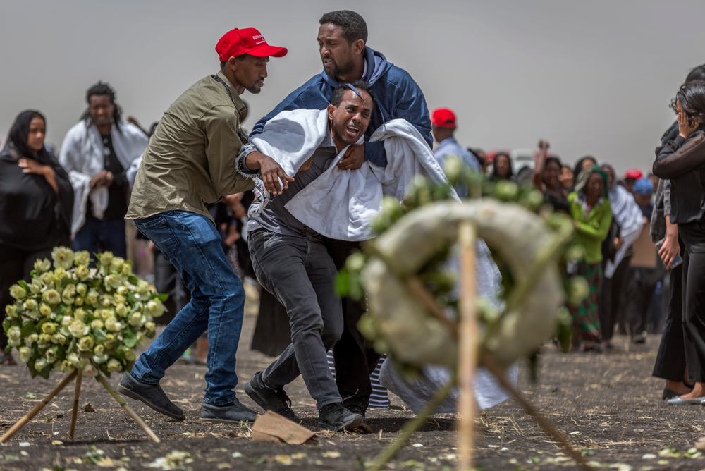 Ethiopian relatives of crash victims mourn and grieve at the scene where the Ethiopian Airlines Boeing 737 Max 8 crashed shortly after takeoff on Sunday killing all 157 on board, near Bishoftu, south-east of Addis Ababa, in Ethiopia Thursday, March 14, 2019. About 200 family members of people who died on the crashed jet stormed out of a briefing with Ethiopian Airlines officials in Addis Ababa on Thursday, complaining that the airline has not given them adequate information. (AP Photo/Mulugeta Ayene) Ethiopian relatives of crash victims mourn and grieve at the scene where the Ethiopian Airlines Boeing 737 Max 8 crashed shortly after takeoff on Sunday killing all 157 on board, near Bishoftu, south-east of Addis Ababa, in Ethiopia Thursday, March 14, 2019. About 200 family members of people who died on the crashed jet stormed out of a briefing with Ethiopian Airlines officials in Addis Ababa on Thursday, complaining that the airline has not given them adequate information. (AP Photo/Mulugeta Ayene)