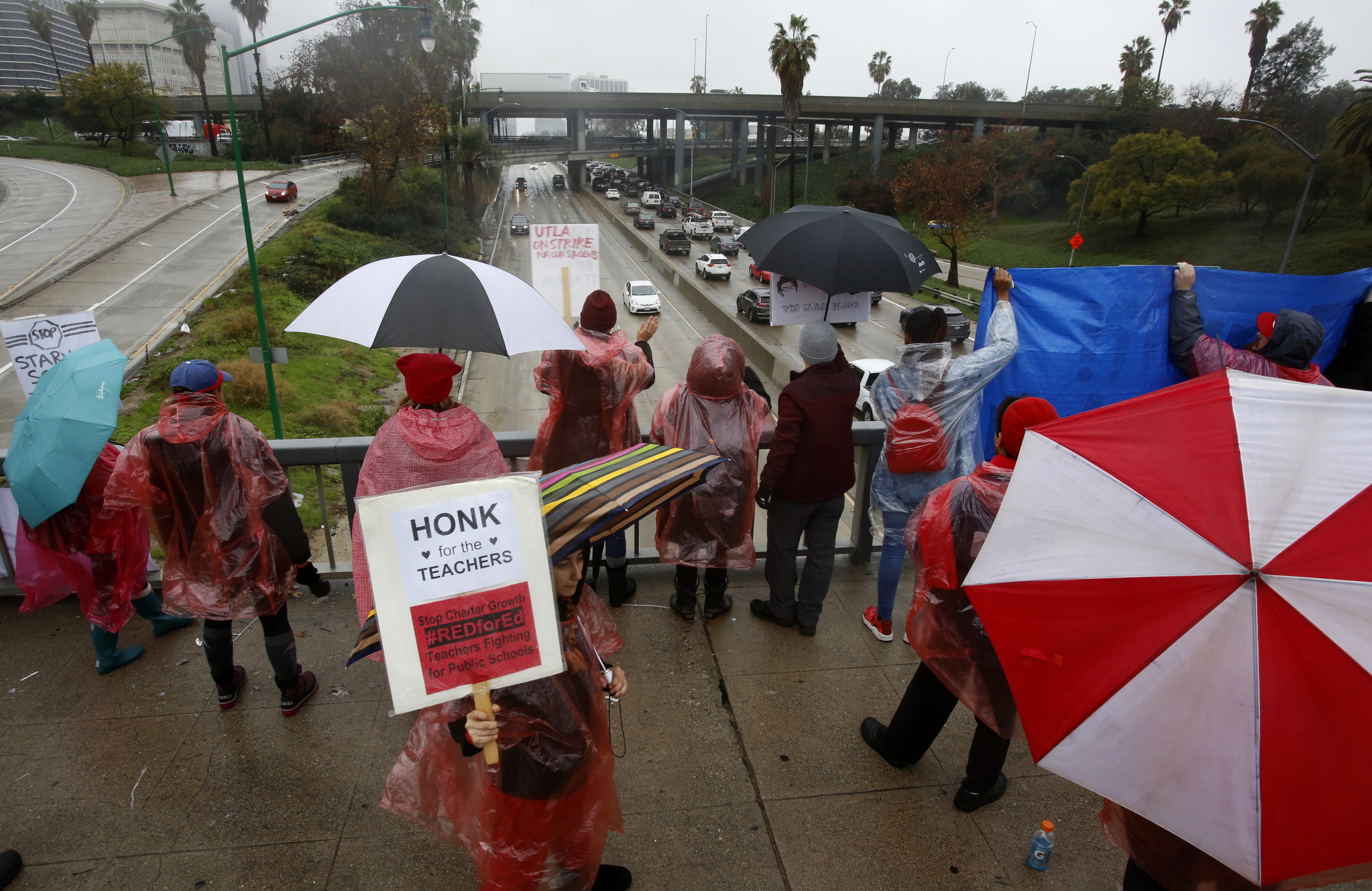 Los Angeles Unified School District educators picket over the Harbor Freeway downtown Los Angeles Thursday, Jan. 17, 2019. A new round of contract negotiations began between Los Angeles school district officials and a teachers union as thousands of educators picketed in the rain. The announcement that the two sides were sitting down Thursday for the first time in nearly a week didn't indicate whether any new contract offers would be on the table. Union officials tempered expectations, saying a quick deal was unlikely. District officials have said teacher demands could bankrupt the school system. (AP Photo/Damian Dovarganes) Los Angeles Unified School District educators picket over the Harbor Freeway downtown Los Angeles Thursday, Jan. 17, 2019. A new round of contract negotiations began between Los Angeles school district officials and a teachers union as thousands of educators picketed in the rain. The announcement that the two sides were sitting down Thursday for the first time in nearly a week didn't indicate whether any new contract offers would be on the table. Union officials tempered expectations, saying a quick deal was unlikely. District officials have said teacher demands could bankrupt the school system. (AP Photo/Damian Dovarganes)