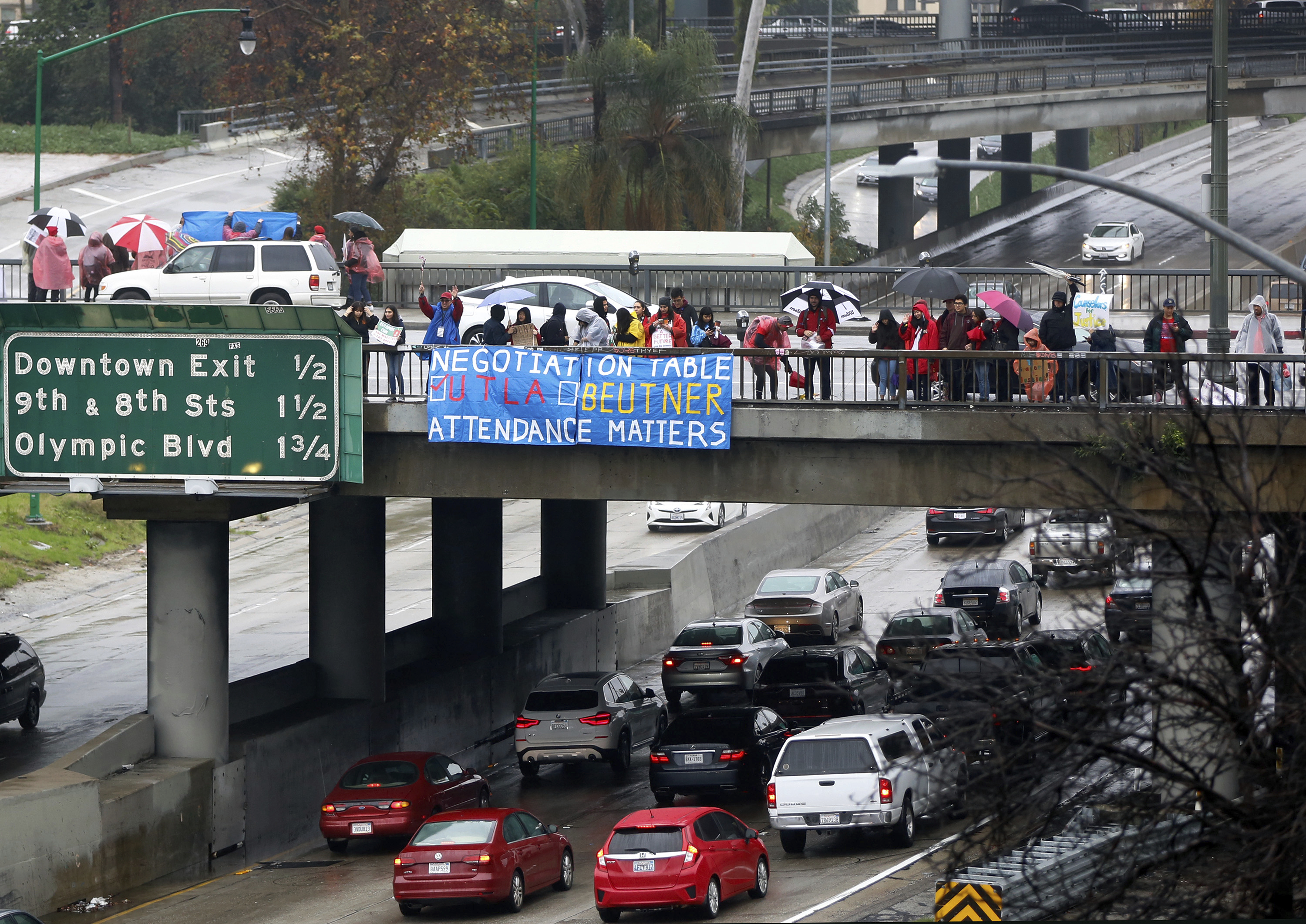 Teachers, parents and children picket despite heavy rain drenching downtown Los Angeles Thursday, Jan. 17, 2019. A new round of contract negotiations began between Los Angeles school district officials and a teachers union as thousands of educators picketed in the rain. The announcement that the two sides were sitting down Thursday for the first time in nearly a week didn't indicate whether any new contract offers would be on the table. Union officials tempered expectations, saying a quick deal was unlikely. District officials have said teacher demands could bankrupt the school system. (AP Photo/Damian Dovarganes) Teachers, parents and children picket despite heavy rain drenching downtown Los Angeles Thursday, Jan. 17, 2019. A new round of contract negotiations began between Los Angeles school district officials and a teachers union as thousands of educators picketed in the rain. The announcement that the two sides were sitting down Thursday for the first time in nearly a week didn't indicate whether any new contract offers would be on the table. Union officials tempered expectations, saying a quick deal was unlikely. District officials have said teacher demands could bankrupt the school system. (AP Photo/Damian Dovarganes)