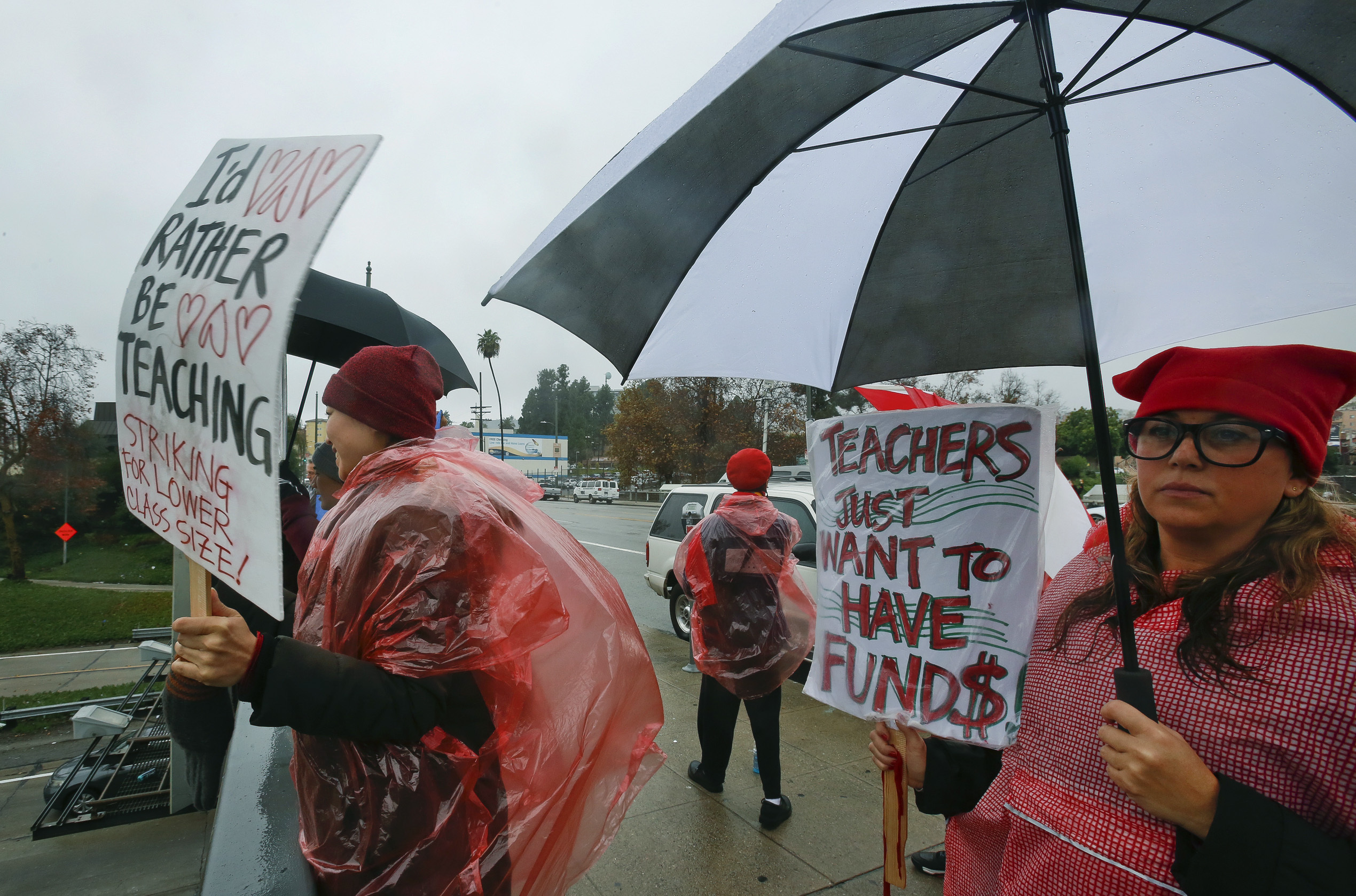 Teachers, parents and students picket under the rain in downtown Los Angeles Thursday, Jan. 17, 2019. A new round of contract negotiations began between Los Angeles school district officials and a teachers union as thousands of educators picketed in the rain. The announcement that the two sides were sitting down Thursday for the first time in nearly a week didn't indicate whether any new contract offers would be on the table. Union officials tempered expectations, saying a quick deal was unlikely. District officials have said teacher demands could bankrupt the school system. (AP Photo/Damian Dovarganes) Teachers, parents and students picket under the rain in downtown Los Angeles Thursday, Jan. 17, 2019. A new round of contract negotiations began between Los Angeles school district officials and a teachers union as thousands of educators picketed in the rain. The announcement that the two sides were sitting down Thursday for the first time in nearly a week didn't indicate whether any new contract offers would be on the table. Union officials tempered expectations, saying a quick deal was unlikely. District officials have said teacher demands could bankrupt the school system. (AP Photo/Damian Dovarganes)