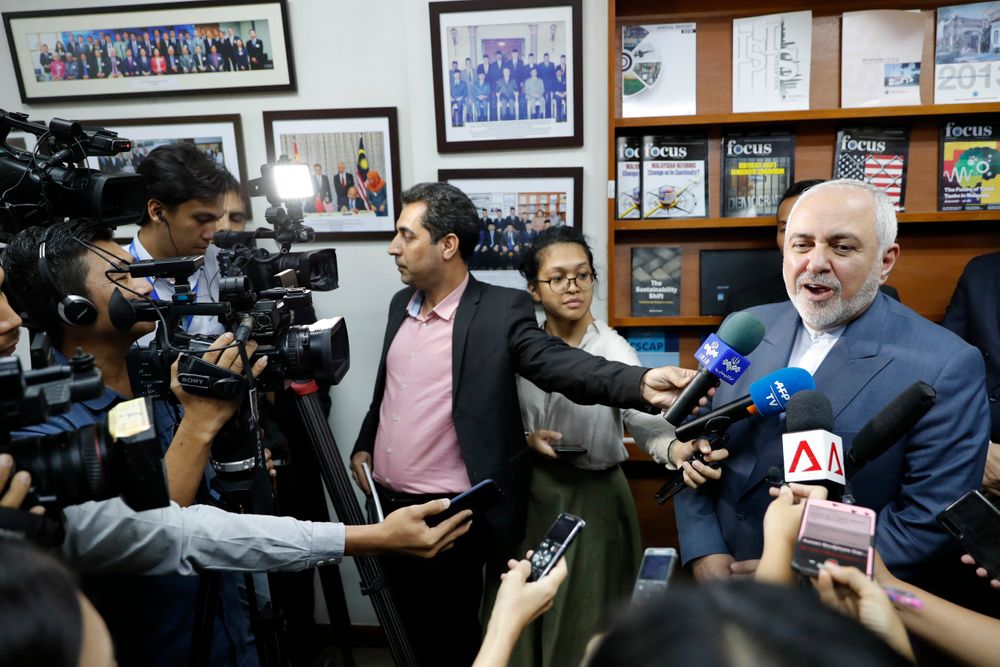 Iranian Foreign Minister Mohammad Javad Zarif, right, speaks to reporters after a forum titled Iranian Foreign Minister Mohammad Javad Zarif, right, speaks to reporters after a forum titled