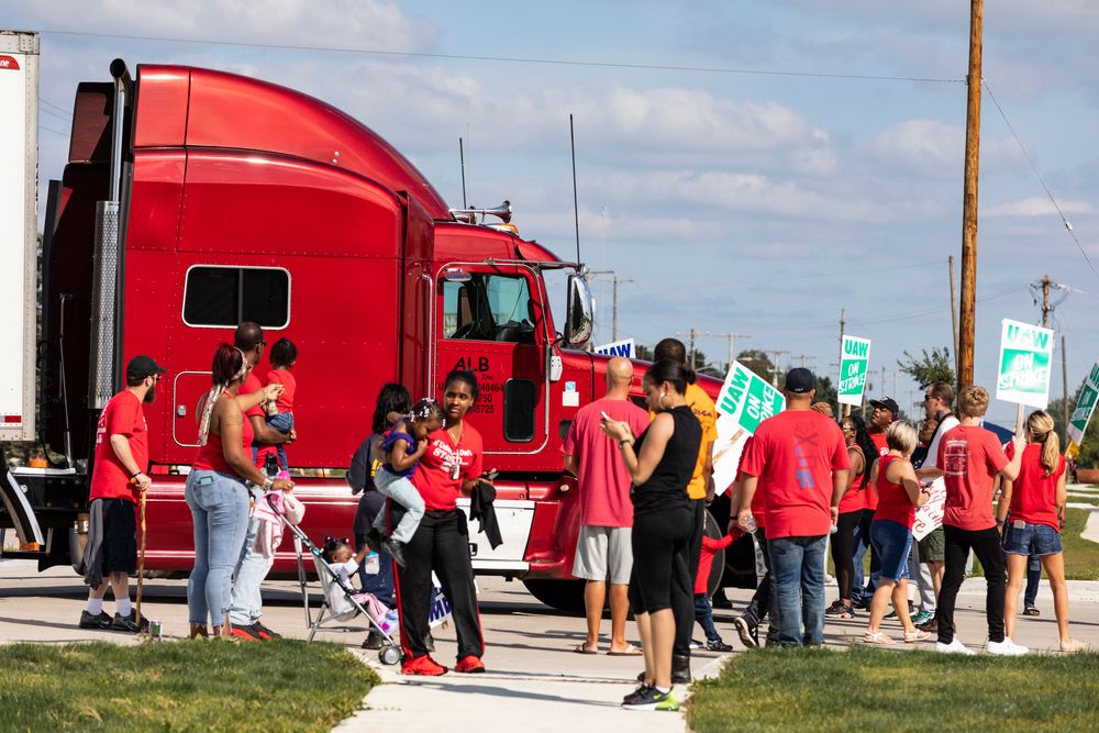 Picketing union members stand-off with a semi-truck attempting to enter the GM Davison Road Processing Center. United Automobile Workers remain on strike against GM on Tuesday, Sept. 17, 2019 in Burton, Mich. (Sara Faraj/The Flint Journal via AP) Picketing union members stand-off with a semi-truck attempting to enter the GM Davison Road Processing Center. United Automobile Workers remain on strike against GM on Tuesday, Sept. 17, 2019 in Burton, Mich. (Sara Faraj/The Flint Journal via AP)