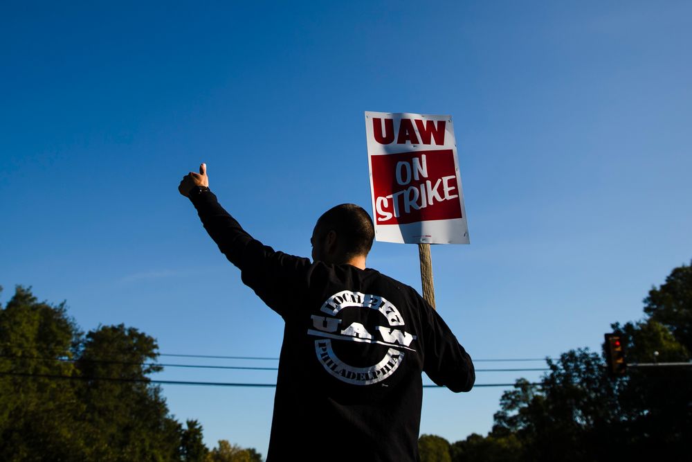 A worker gives the thumbs-up gesture to a passing motorist as he demonstratives outside a General Motors facility in Langhorne, Pa., Tuesday, Sept. 17, 2019. More than 49,000 members of the United Auto Workers walked off General Motors factory floors or set up picket lines early Monday as contract talks with the company deteriorated into a strike. (AP Photo/Matt Rourke) A worker gives the thumbs-up gesture to a passing motorist as he demonstratives outside a General Motors facility in Langhorne, Pa., Tuesday, Sept. 17, 2019. More than 49,000 members of the United Auto Workers walked off General Motors factory floors or set up picket lines early Monday as contract talks with the company deteriorated into a strike. (AP Photo/Matt Rourke)