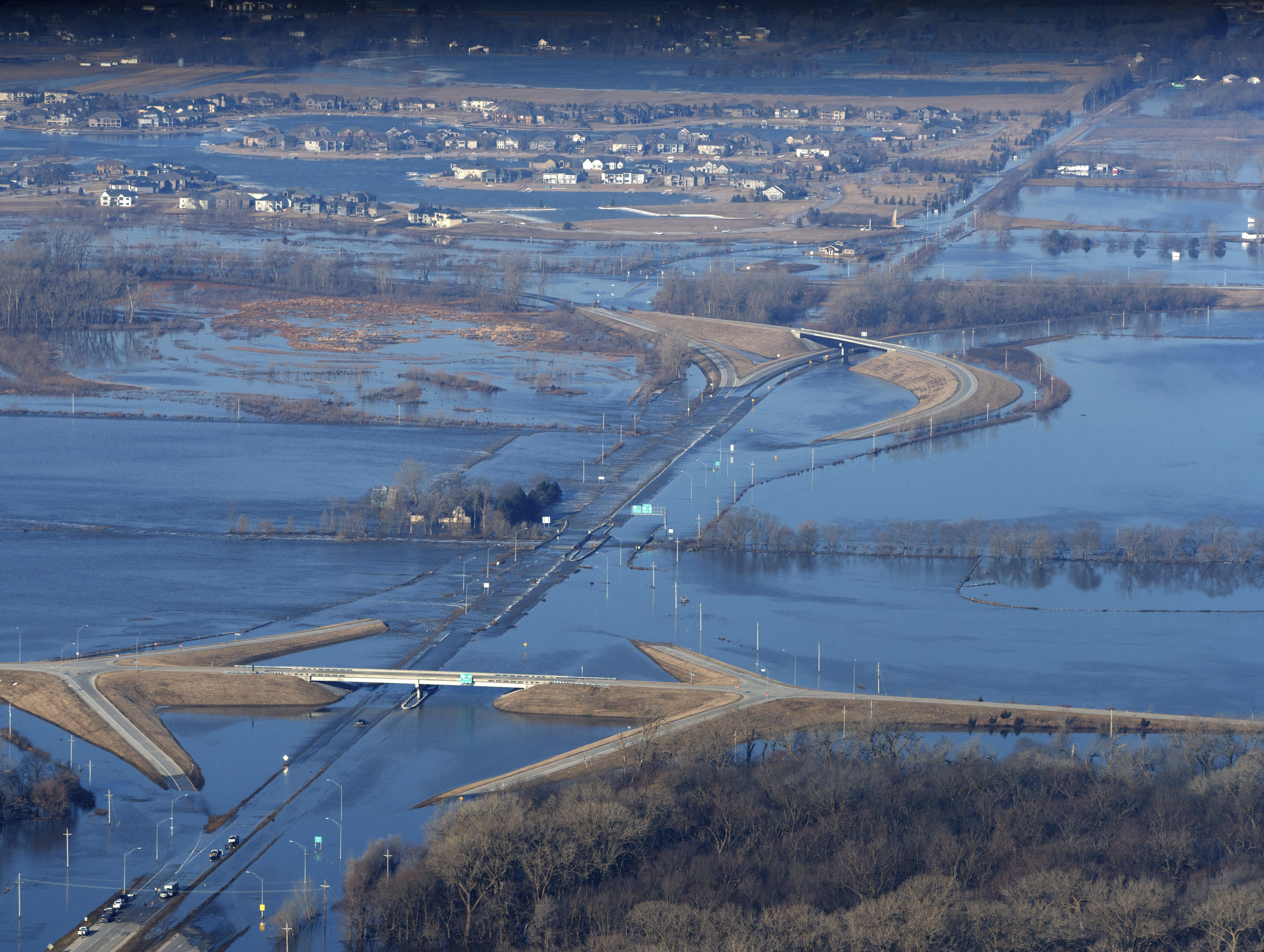 CORRECTS MONTH TO MARCH NOT MAY - The Elkhorn River consumes a section of western Douglas County Sunday, March 17, 2019, in Omaha, Neb. Hundreds of people were evacuated from their homes in Nebraska and Iowa as levees succumbed to the rush of water. (Jeff Bundy/Omaha World-Herald via AP) CORRECTS MONTH TO MARCH NOT MAY - The Elkhorn River consumes a section of western Douglas County Sunday, March 17, 2019, in Omaha, Neb. Hundreds of people were evacuated from their homes in Nebraska and Iowa as levees succumbed to the rush of water. (Jeff Bundy/Omaha World-Herald via AP)