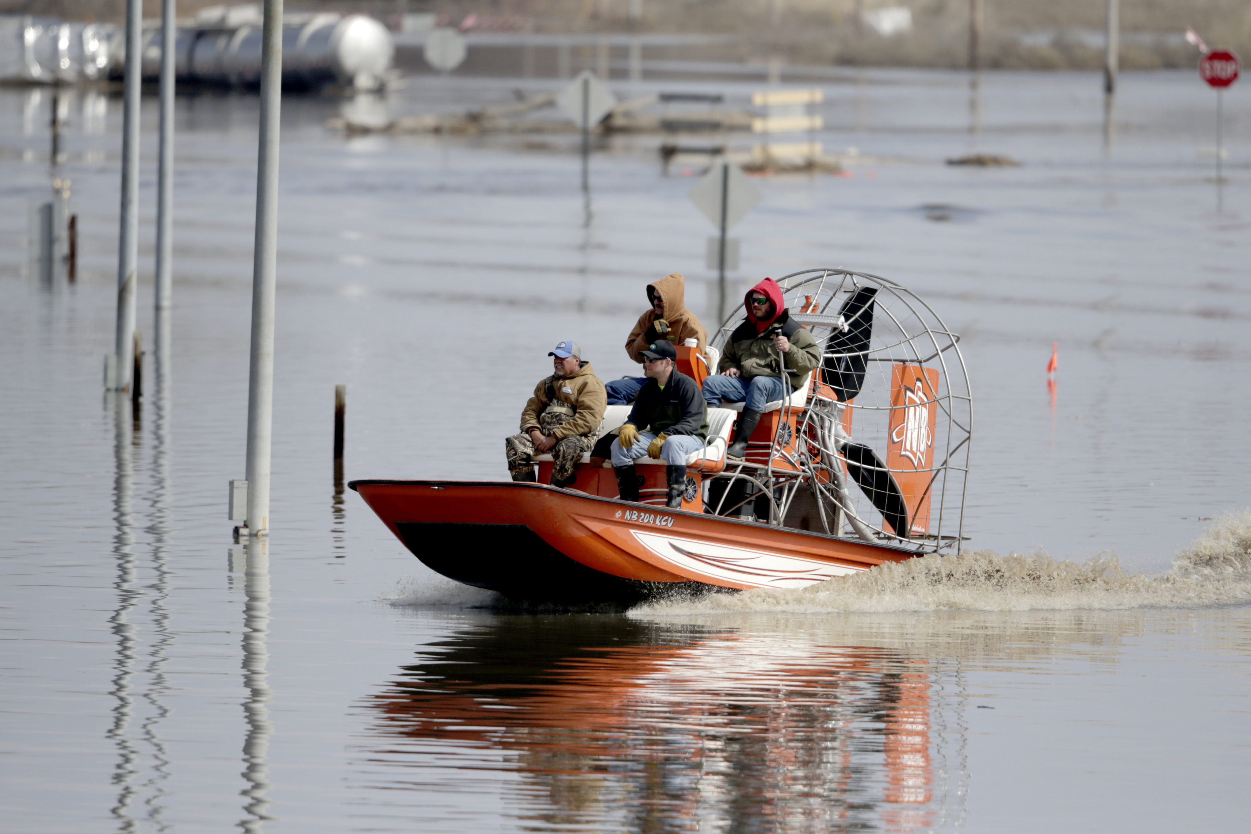 Gabe Schmidt, owner of Liquid Trucking, back right, travels by air boat with Glenn Wyles, top left, Mitch Snyder, bottom right, and Juan Jacobo, bottom left, as they survey damage from the flood waters of the Platte River, in Plattsmouth, Neb., Sunday, March 17, 2019. Hundreds of people remained out of their homes in Nebraska, but rivers there were starting to recede. The National Weather Service said the Elkhorn River remained at major flood stage but was dropping. (AP Photo/Nati Harnik) Gabe Schmidt, owner of Liquid Trucking, back right, travels by air boat with Glenn Wyles, top left, Mitch Snyder, bottom right, and Juan Jacobo, bottom left, as they survey damage from the flood waters of the Platte River, in Plattsmouth, Neb., Sunday, March 17, 2019. Hundreds of people remained out of their homes in Nebraska, but rivers there were starting to recede. The National Weather Service said the Elkhorn River remained at major flood stage but was dropping. (AP Photo/Nati Harnik)