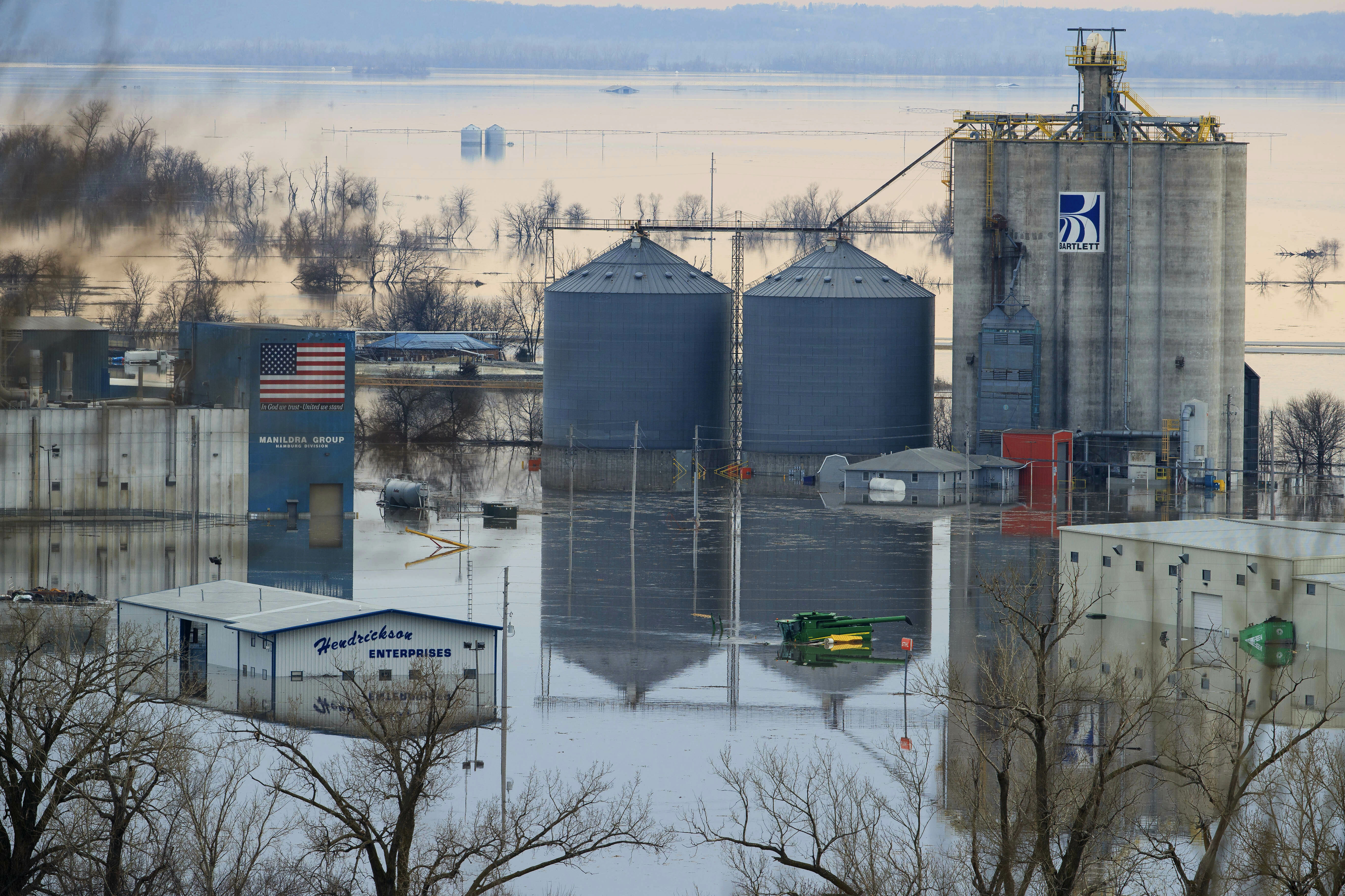 CORRECTS TO MARCH FROM MAY - Floodwaters surround buildings on the southwest side of Hamburg, Iowa, Sunday, March 17, 2019. Residents in parts of southwestern Iowa were forced out of their homes Sunday as a torrent of Missouri River water flowed over and through levees, putting them in a situation similar to hundreds of people in neighboring Nebraska who have been displaced by the late-winter flood. (Ryan Soderlin/Omaha World-Herald via AP) CORRECTS TO MARCH FROM MAY - Floodwaters surround buildings on the southwest side of Hamburg, Iowa, Sunday, March 17, 2019. Residents in parts of southwestern Iowa were forced out of their homes Sunday as a torrent of Missouri River water flowed over and through levees, putting them in a situation similar to hundreds of people in neighboring Nebraska who have been displaced by the late-winter flood. (Ryan Soderlin/Omaha World-Herald via AP)