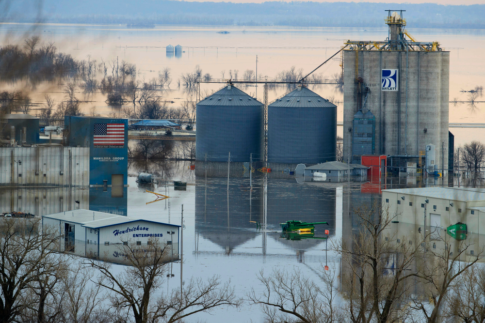 CORRECTS TO MARCH FROM MAY - Floodwaters surround buildings on the southwest side of Hamburg, Iowa, Sunday, March 17, 2019. Residents in parts of southwestern Iowa were forced out of their homes Sunday as a torrent of Missouri River water flowed over and through levees, putting them in a situation similar to hundreds of people in neighboring Nebraska who have been displaced by the late-winter flood. (Ryan Soderlin/Omaha World-Herald via AP) CORRECTS TO MARCH FROM MAY - Floodwaters surround buildings on the southwest side of Hamburg, Iowa, Sunday, March 17, 2019. Residents in parts of southwestern Iowa were forced out of their homes Sunday as a torrent of Missouri River water flowed over and through levees, putting them in a situation similar to hundreds of people in neighboring Nebraska who have been displaced by the late-winter flood. (Ryan Soderlin/Omaha World-Herald via AP)