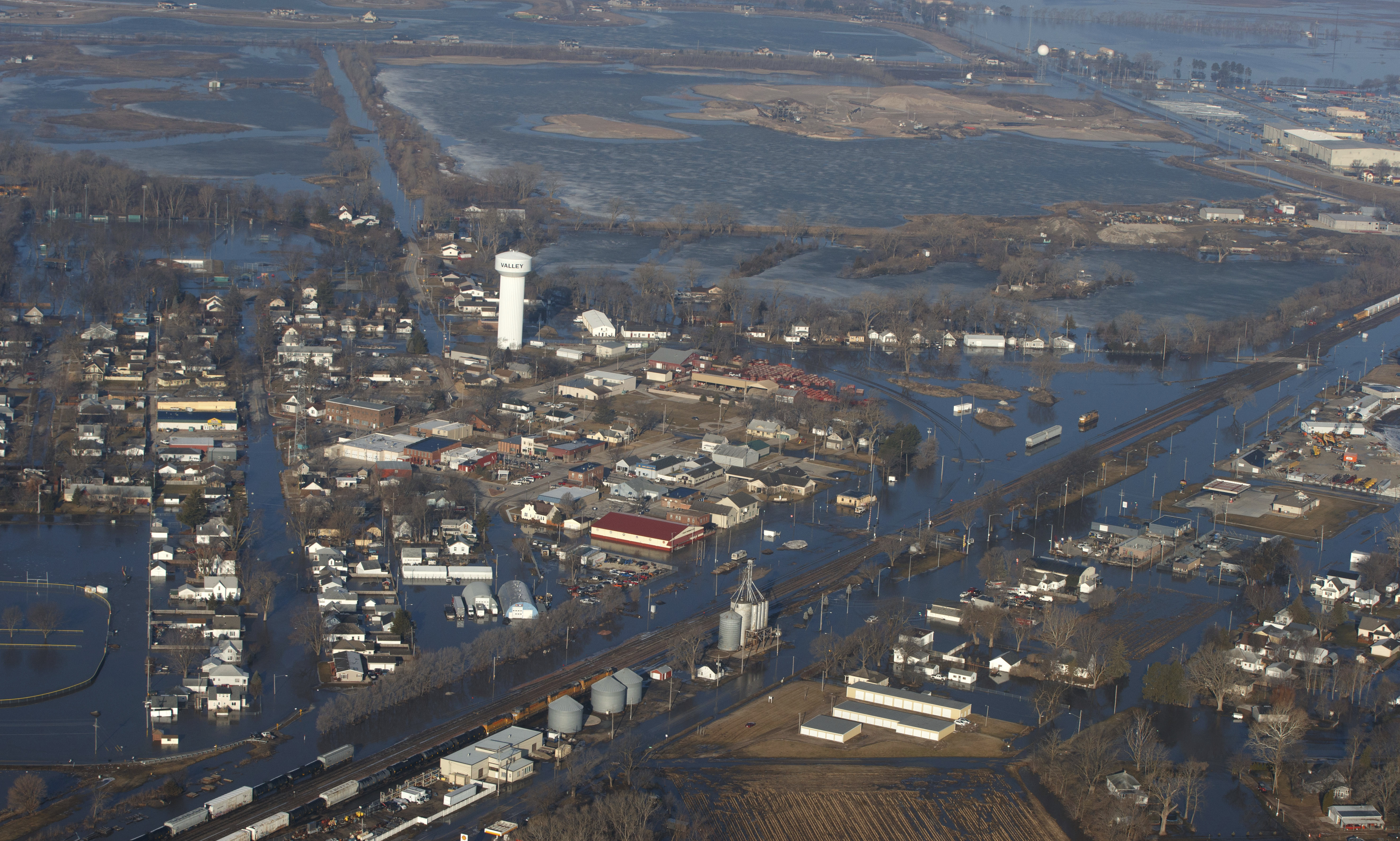 CORRECTS MONTH TO MARCH NOT MAY - The city of Valley is inundated with floodwaters Sunday, March 17, 2019, in Valley, Neb. Hundreds of people were evacuated from their homes in Nebraska and Iowa as levees succumbed to the rush of water. (Jeff Bundy/Omaha World-Herald via AP) CORRECTS MONTH TO MARCH NOT MAY - The city of Valley is inundated with floodwaters Sunday, March 17, 2019, in Valley, Neb. Hundreds of people were evacuated from their homes in Nebraska and Iowa as levees succumbed to the rush of water. (Jeff Bundy/Omaha World-Herald via AP)