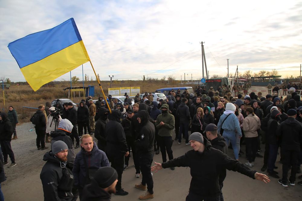 Ukrainian army veterans and volunteers wave the national flag at a checkpoint near the village of Zolote in the Luhansk region, Ukraine, Wednesday, Oct. 9, 2019. Several dozen activists arrived on Wednesday in the area of a much anticipated pullback of heavy weaponry from both sides of the de facto border, saying that they would try to prevent it from happening. (AP Photo/Bohdan Kutepov) Ukrainian army veterans and volunteers wave the national flag at a checkpoint near the village of Zolote in the Luhansk region, Ukraine, Wednesday, Oct. 9, 2019. Several dozen activists arrived on Wednesday in the area of a much anticipated pullback of heavy weaponry from both sides of the de facto border, saying that they would try to prevent it from happening. (AP Photo/Bohdan Kutepov)