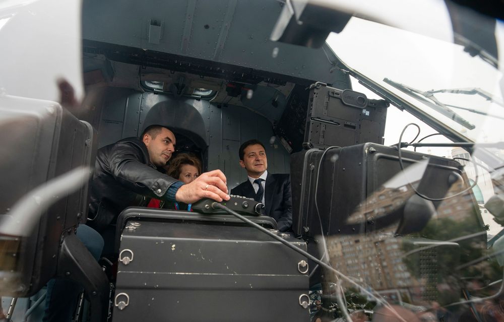 In this handout photo provided by the Ukrainian Presidential Press Office, Ukrainian President Volodymyr Zelenskiy, right, sits inside a military helicopter as he visits an arm exhibition in Kyiv, Ukraine, Wednesday, Oct. 9, 2019. (Ukrainian Presidential Press Office via AP) In this handout photo provided by the Ukrainian Presidential Press Office, Ukrainian President Volodymyr Zelenskiy, right, sits inside a military helicopter as he visits an arm exhibition in Kyiv, Ukraine, Wednesday, Oct. 9, 2019. (Ukrainian Presidential Press Office via AP)
