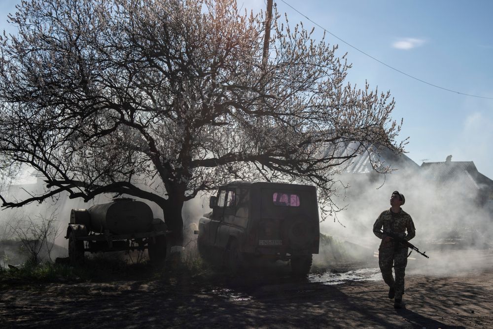 FILE - In this April 20, 2019, file photo, a Ukrainian serviceman guards a position near the front line as the conflict continues, in Marinka, Donetsk region, eastern Ukraine. Ukraine signed much-anticipated accords with separatists from the country's east, Russia and European monitors on Tuesday, Oct. 1, 2019, that agree a local election can be held in separatist-controlled territory, paving the way for peace talks with Moscow. (AP Photo/Evgeniy Maloletka, File) FILE - In this April 20, 2019, file photo, a Ukrainian serviceman guards a position near the front line as the conflict continues, in Marinka, Donetsk region, eastern Ukraine. Ukraine signed much-anticipated accords with separatists from the country's east, Russia and European monitors on Tuesday, Oct. 1, 2019, that agree a local election can be held in separatist-controlled territory, paving the way for peace talks with Moscow. (AP Photo/Evgeniy Maloletka, File)