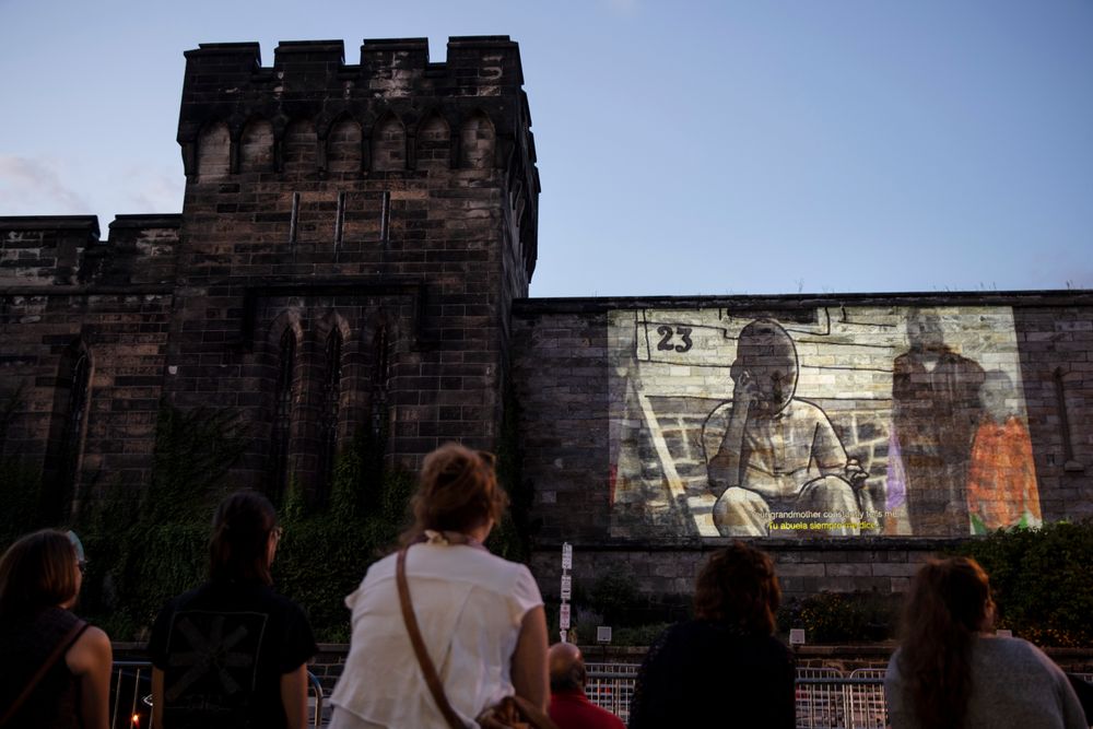 In this Tuesday, Sept. 3, 2019 photo, people view incarcerated filmmaker Robert's animated short titled In this Tuesday, Sept. 3, 2019 photo, people view incarcerated filmmaker Robert's animated short titled