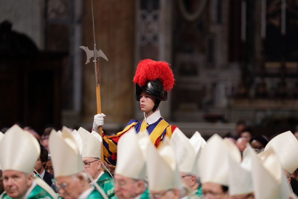 A Swiss guard stands attention as prelates attend an opening Mass for the Amazon synod, in St. Peter's Basilica, at the Vatican, Sunday, Oct. 6, 2019. Pope Francis is opening a divisive meeting on preserving the Amazon and ministering to its indigenous peoples, as he fends off attacks from conservatives who are opposed to his ecological agenda. (AP Photo/Andrew Medichini) A Swiss guard stands attention as prelates attend an opening Mass for the Amazon synod, in St. Peter's Basilica, at the Vatican, Sunday, Oct. 6, 2019. Pope Francis is opening a divisive meeting on preserving the Amazon and ministering to its indigenous peoples, as he fends off attacks from conservatives who are opposed to his ecological agenda. (AP Photo/Andrew Medichini)