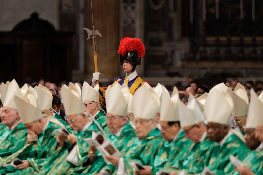 A Swiss guard stands attention as Pope Francis celebrates an opening Mass for the Amazon synod, in St. Peter's Basilica, at the Vatican, Sunday, Oct. 6, 2019. Pope Francis is opening a divisive meeting on preserving the Amazon and ministering to its indigenous peoples, as he fends off attacks from conservatives who are opposed to his ecological agenda.(AP Photo/Andrew Medichini) A Swiss guard stands attention as Pope Francis celebrates an opening Mass for the Amazon synod, in St. Peter's Basilica, at the Vatican, Sunday, Oct. 6, 2019. Pope Francis is opening a divisive meeting on preserving the Amazon and ministering to its indigenous peoples, as he fends off attacks from conservatives who are opposed to his ecological agenda.(AP Photo/Andrew Medichini)