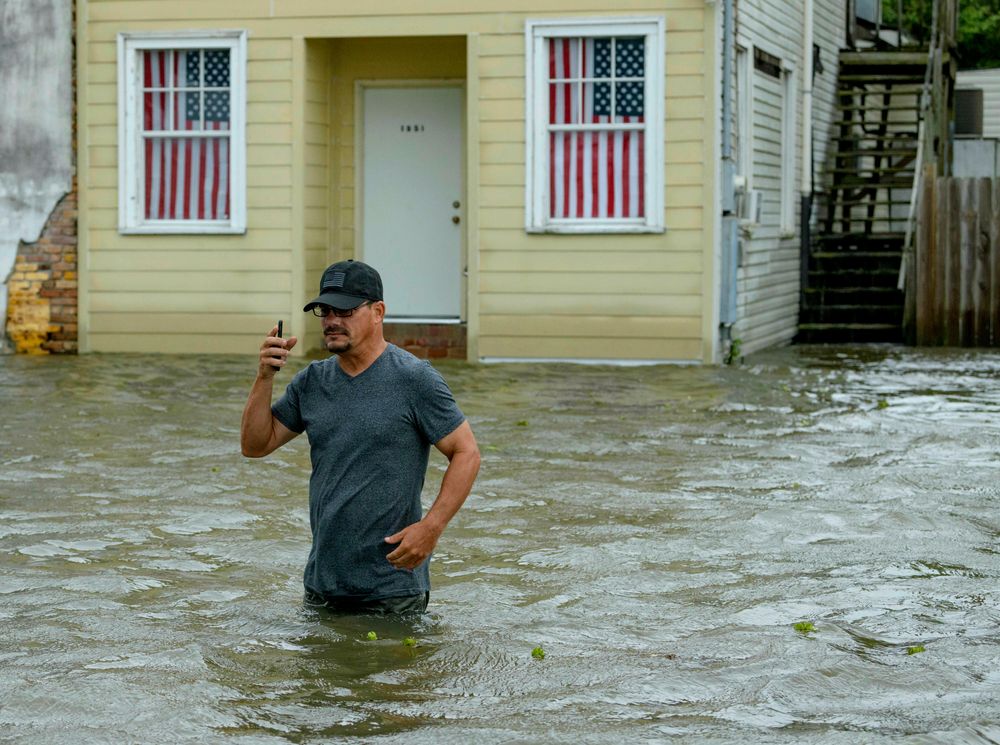 Barry Williams talks to a friend on his smartphone as he wades through storm surge from Lake Pontchartrain on Lakeshore Drive in Mandeville, La., as Hurricane Barry approaches Saturday, July 13, 2019. After briefly becoming a Category 1 hurricane, the system quickly weakened to a tropical storm as it made landfall near Intracoastal City, Louisiana, about 160 miles (257km) west of New Orleans, with its winds falling to 70 mph (112km), the National Hurricane Center said. (AP Photo/Matthew Hinton) Barry Williams talks to a friend on his smartphone as he wades through storm surge from Lake Pontchartrain on Lakeshore Drive in Mandeville, La., as Hurricane Barry approaches Saturday, July 13, 2019. After briefly becoming a Category 1 hurricane, the system quickly weakened to a tropical storm as it made landfall near Intracoastal City, Louisiana, about 160 miles (257km) west of New Orleans, with its winds falling to 70 mph (112km), the National Hurricane Center said. (AP Photo/Matthew Hinton)