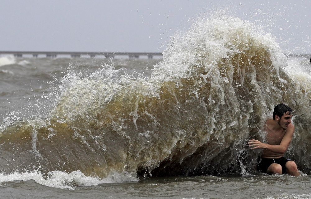 Brady Dayries is hit by a wave as winds from Tropical Storm Barry push water from Lake Pontchartrain over the seawall Saturday, July 13, 2019, in Mandeville, La. (AP Photo/David J. Phillip) Brady Dayries is hit by a wave as winds from Tropical Storm Barry push water from Lake Pontchartrain over the seawall Saturday, July 13, 2019, in Mandeville, La. (AP Photo/David J. Phillip)