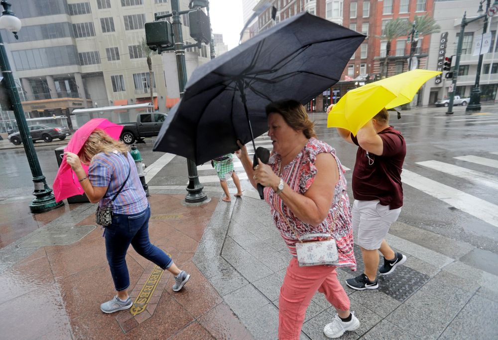 Martha Young, center, Patricia Plishka, left, and her husband Glen, right, battle the wind and rain from Hurricane Barry as it nears landfall Saturday, July 13, 2019, in New Orleans. (AP Photo/David J. Phillip) Martha Young, center, Patricia Plishka, left, and her husband Glen, right, battle the wind and rain from Hurricane Barry as it nears landfall Saturday, July 13, 2019, in New Orleans. (AP Photo/David J. Phillip)