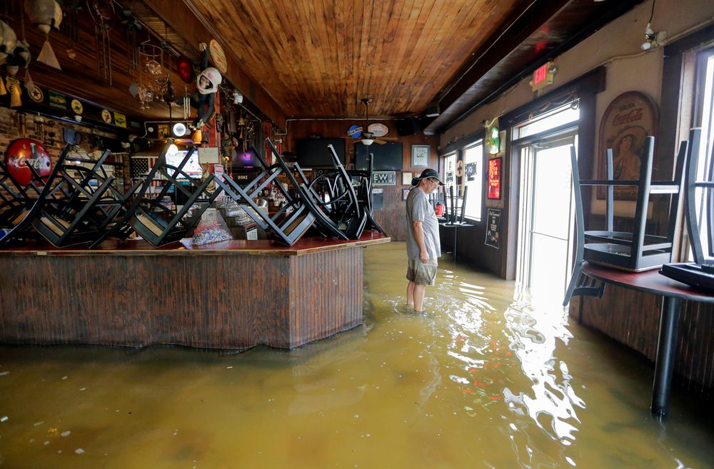 A man stands in floodwaters at Don'z On the Lake as Tropical Storm Barry's winds push water over the Lake Pontchartrain seawall Saturday, July 13, 2019. (David Grunfeld/The Advocate via AP) A man stands in floodwaters at Don'z On the Lake as Tropical Storm Barry's winds push water over the Lake Pontchartrain seawall Saturday, July 13, 2019. (David Grunfeld/The Advocate via AP)