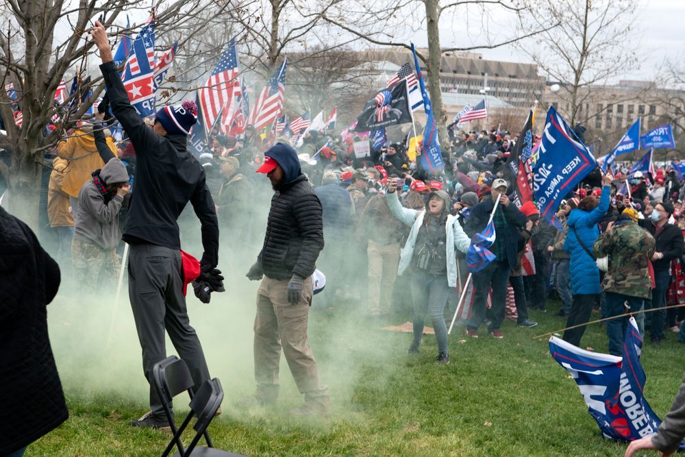  In this Jan. 6, 2021, file photo, supporter of President Donald Trump protest as U.S. Capitol Police officers shoot tear gas at demonstrators outside of the U.S. Capitol in Washington. 