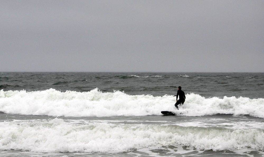 A surfer rides a wave at Narragansett Town Beach on September 2, 2020.