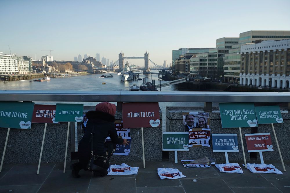 A member of the Faiths Forum for London places tributes on London Bridge in London, Monday, Dec. 2, 2019. London Bridge reopened to cars and pedestrians Monday, three days after a man previously convicted of terrorism offenses stabbed two people to death and injured three others before being shot dead by police. (AP Photo/Matt Dunham) A member of the Faiths Forum for London places tributes on London Bridge in London, Monday, Dec. 2, 2019. London Bridge reopened to cars and pedestrians Monday, three days after a man previously convicted of terrorism offenses stabbed two people to death and injured three others before being shot dead by police. (AP Photo/Matt Dunham)