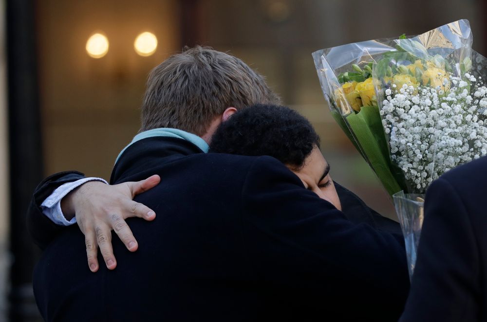 People embrace before attending a vigil at Guildhall Yard in London, Monday Dec. 2, 2019, to remember the London attack victims and honor members of the emergency services and bystanders who fought the attacker. London Bridge reopened to cars and pedestrians Monday, three days after a man previously convicted of terrorism offenses stabbed two people to death and injured three others before being shot dead by police. (AP Photo/Matt Dunham) People embrace before attending a vigil at Guildhall Yard in London, Monday Dec. 2, 2019, to remember the London attack victims and honor members of the emergency services and bystanders who fought the attacker. London Bridge reopened to cars and pedestrians Monday, three days after a man previously convicted of terrorism offenses stabbed two people to death and injured three others before being shot dead by police. (AP Photo/Matt Dunham)