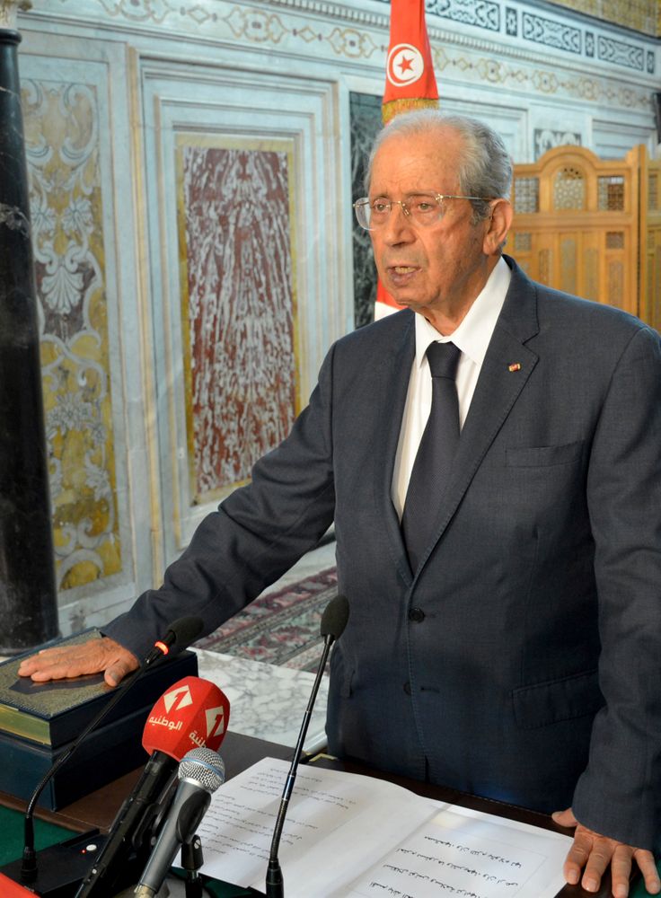 Tunisian parliament president Mohamed Ennaceur, puts his hand on the Quran to be sworn in as Tunisian interim President in Tunis, Tunisia, Thursday, July 25, 2019. Ennaceur, the leader of Tunisia's parliament has been sworn in as the interim president of the North African country after 92-year-old President Beji Essebsi died in office. The state news agency TAP reported that Mohamed Ennaceur, president of the Assembly of People's Representatives, took the oath of office Thursday July 25, hours after Essebsi's death in the morning. (Lassad Manai/Tunisian Assembly via AP) Tunisian parliament president Mohamed Ennaceur, puts his hand on the Quran to be sworn in as Tunisian interim President in Tunis, Tunisia, Thursday, July 25, 2019. Ennaceur, the leader of Tunisia's parliament has been sworn in as the interim president of the North African country after 92-year-old President Beji Essebsi died in office. The state news agency TAP reported that Mohamed Ennaceur, president of the Assembly of People's Representatives, took the oath of office Thursday July 25, hours after Essebsi's death in the morning. (Lassad Manai/Tunisian Assembly via AP)