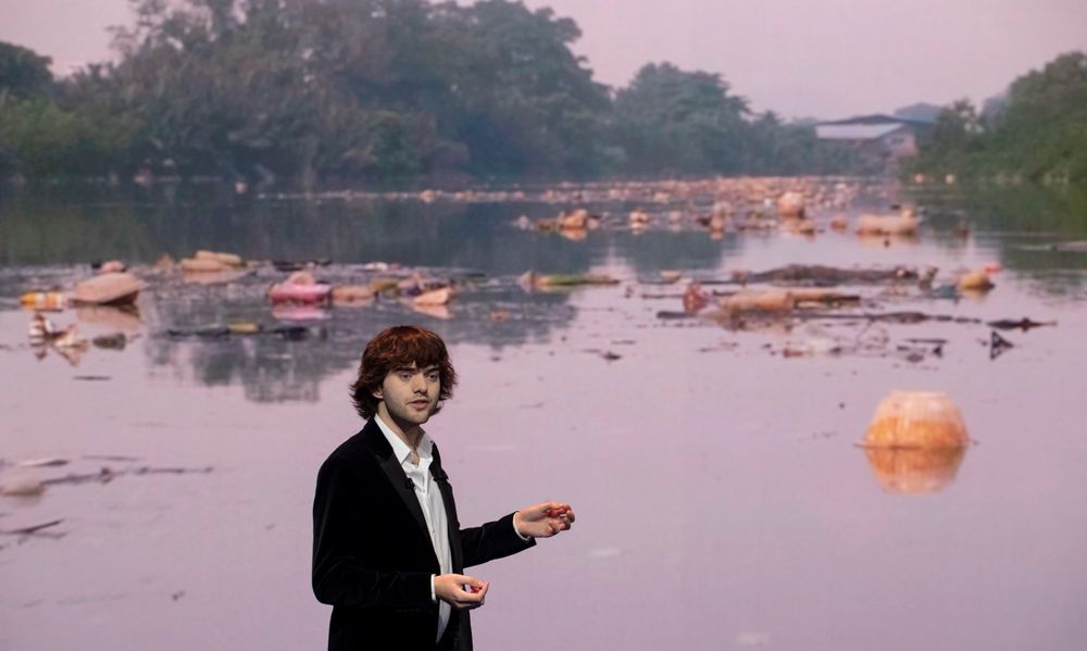 Young Dutch inventor Boyan Slat presents his plans for the Interceptor, a plastic-gathering floating device, in front of a video of a polluted river, during a presentation in Rotterdam, Netherlands, Saturday, Oct. 26, 2019. Slat is taking his effort to clean up floating plastic from the Pacific Ocean to rivers to catch garbage before it reaches the seas. (AP Photo/Peter Dejong) Young Dutch inventor Boyan Slat presents his plans for the Interceptor, a plastic-gathering floating device, in front of a video of a polluted river, during a presentation in Rotterdam, Netherlands, Saturday, Oct. 26, 2019. Slat is taking his effort to clean up floating plastic from the Pacific Ocean to rivers to catch garbage before it reaches the seas. (AP Photo/Peter Dejong)