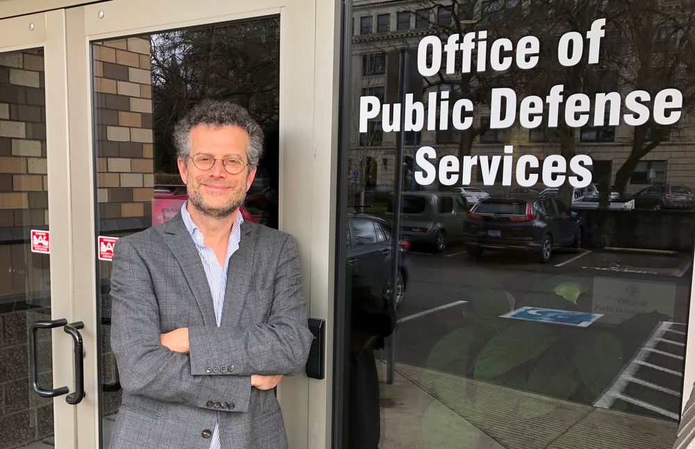 FILE - In this photo taken April 12, 2019 photo, Marc Brown, a lawyer with Oregon's Office of Public Defense Services-Criminal Appeals Section, poses in Salem, Ore. Oregon's attorney general is telling the U.S. Supreme Court that Oregon's criminal justice system would be FILE - In this photo taken April 12, 2019 photo, Marc Brown, a lawyer with Oregon's Office of Public Defense Services-Criminal Appeals Section, poses in Salem, Ore. Oregon's attorney general is telling the U.S. Supreme Court that Oregon's criminal justice system would be