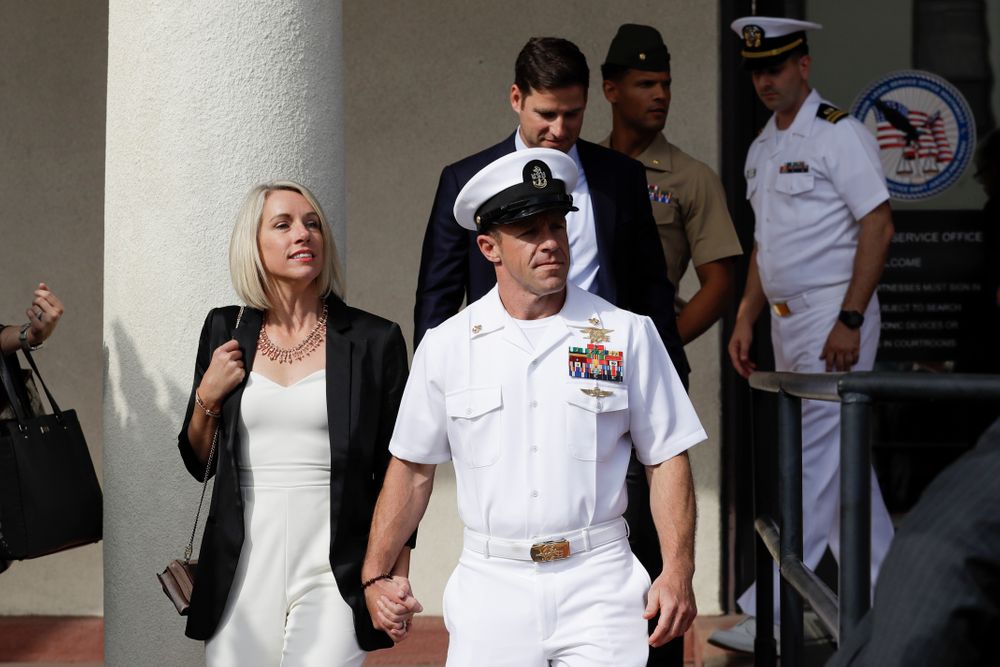 Navy Special Operations Chief Edward Gallagher, center, walks with his wife, Andrea Gallagher, as they leave a military court on Naval Base San Diego, Tuesday, July 2, 2019, in San Diego. A military jury acquitted the decorated Navy SEAL Tuesday of murder in the killing of a wounded Islamic State captive under his care in Iraq in 2017. (AP Photo/Gregory Bull) Navy Special Operations Chief Edward Gallagher, center, walks with his wife, Andrea Gallagher, as they leave a military court on Naval Base San Diego, Tuesday, July 2, 2019, in San Diego. A military jury acquitted the decorated Navy SEAL Tuesday of murder in the killing of a wounded Islamic State captive under his care in Iraq in 2017. (AP Photo/Gregory Bull)