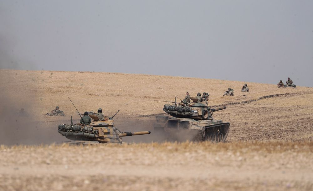 Turkish tanks and troops stationed near Syrian town of Manbij, Syria, Tuesday. Oct. 15, 2019. Russia moved to fill the void left by the United States in northern Syria on Tuesday, deploying troops to keep apart advancing Syrian government and Turkish forces.(Ugur Can/DHA via AP) Turkish tanks and troops stationed near Syrian town of Manbij, Syria, Tuesday. Oct. 15, 2019. Russia moved to fill the void left by the United States in northern Syria on Tuesday, deploying troops to keep apart advancing Syrian government and Turkish forces.(Ugur Can/DHA via AP)