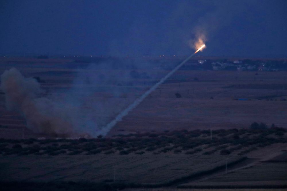 In this photo taken from the Turkish side of the border between Turkey and Syria, in Ceylanpinar, Sanliurfa province, southeastern Turkey, Turkish forces fire rockets towards targets in Ras al-Ayn, Syria, Tuesday, Oct. 15, 2019. (AP Photo/Lefteris Pitarakis) In this photo taken from the Turkish side of the border between Turkey and Syria, in Ceylanpinar, Sanliurfa province, southeastern Turkey, Turkish forces fire rockets towards targets in Ras al-Ayn, Syria, Tuesday, Oct. 15, 2019. (AP Photo/Lefteris Pitarakis)
