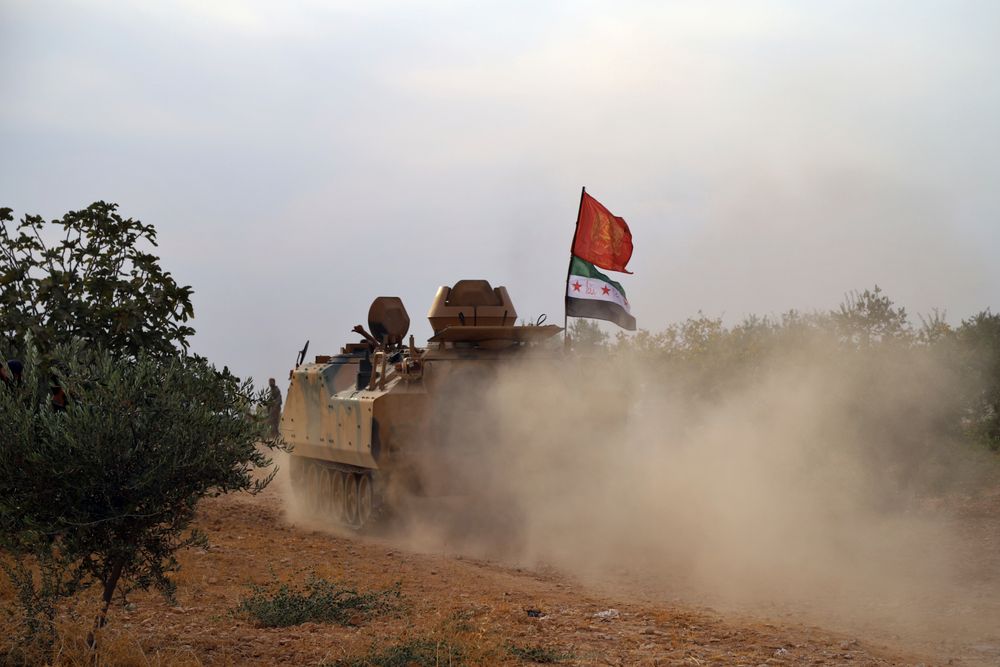 In this Monday, Oct. 14, 2019 photo, Turkey-backed Syrian opposition fighters move in an armored vehicle in Syria's northern region of Manbij. Syrian state media said Tuesday that government forces have entered the center of the once Kurdish-held northern town of Manbij and raised the national flag. (AP Photo) In this Monday, Oct. 14, 2019 photo, Turkey-backed Syrian opposition fighters move in an armored vehicle in Syria's northern region of Manbij. Syrian state media said Tuesday that government forces have entered the center of the once Kurdish-held northern town of Manbij and raised the national flag. (AP Photo)