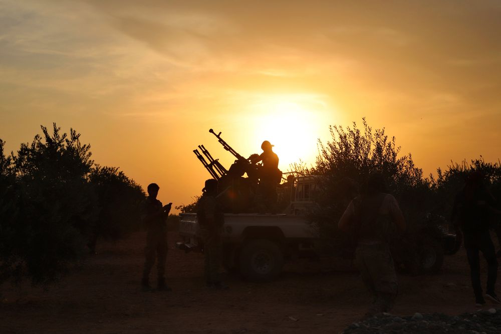 In this Monday, Oct. 14, 2019 photo, Turkey-backed Syrian opposition fighters prepare their guns in Syria's northern region of Manbij. Syrian state media said Tuesday that government forces have entered the center of the once Kurdish-held northern town of Manbij and raised the national flag. (AP Photo) In this Monday, Oct. 14, 2019 photo, Turkey-backed Syrian opposition fighters prepare their guns in Syria's northern region of Manbij. Syrian state media said Tuesday that government forces have entered the center of the once Kurdish-held northern town of Manbij and raised the national flag. (AP Photo)