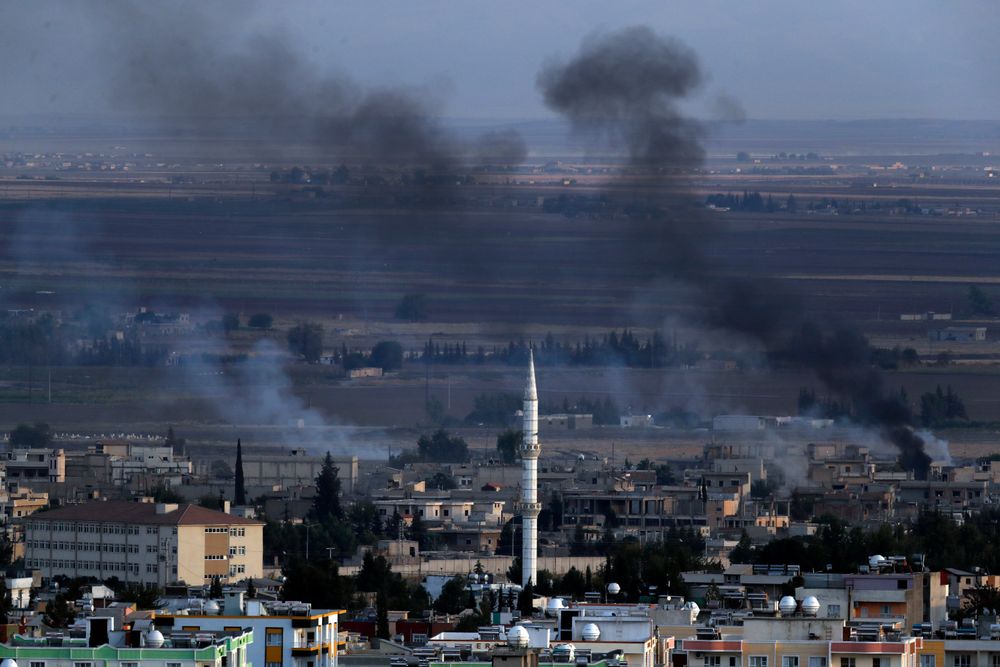In this photo taken from the Turkish side of the border between Turkey and Syria, in Ceylanpinar, Sanliurfa province, southeastern Turkey, smoke billows from targets in Ras al-Ayn, Syria, caused by bombardment by Turkish forces, Tuesday, Oct. 15, 2019. Turkish artillery on Tuesday pounded suspected Syrian Kurdish positions near the town in northeast Syria amid reports that Kurdish fighters had retaken the town as Turkey pressed ahead with a military incursion that has drawn widespread condemnation. (AP Photo/Lefteris Pitarakis) In this photo taken from the Turkish side of the border between Turkey and Syria, in Ceylanpinar, Sanliurfa province, southeastern Turkey, smoke billows from targets in Ras al-Ayn, Syria, caused by bombardment by Turkish forces, Tuesday, Oct. 15, 2019. Turkish artillery on Tuesday pounded suspected Syrian Kurdish positions near the town in northeast Syria amid reports that Kurdish fighters had retaken the town as Turkey pressed ahead with a military incursion that has drawn widespread condemnation. (AP Photo/Lefteris Pitarakis)