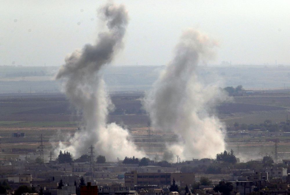 In this photo taken from the Turkish side of the border between Turkey and Syria, in Ceylanpinar, Sanliurfa province, southeastern Turkey, smoke and dust billows from targets in Ras al-Ayn, Syria, caused by bombardment by Turkish forces, Tuesday, Oct. 15, 2019. Turkish artillery on Tuesday pounded suspected Syrian Kurdish positions near the town in northeast Syria amid reports that Kurdish fighters had retaken the town as Turkey pressed ahead with a military incursion that has drawn widespread condemnation. (AP Photo/Cavit Ozgul) In this photo taken from the Turkish side of the border between Turkey and Syria, in Ceylanpinar, Sanliurfa province, southeastern Turkey, smoke and dust billows from targets in Ras al-Ayn, Syria, caused by bombardment by Turkish forces, Tuesday, Oct. 15, 2019. Turkish artillery on Tuesday pounded suspected Syrian Kurdish positions near the town in northeast Syria amid reports that Kurdish fighters had retaken the town as Turkey pressed ahead with a military incursion that has drawn widespread condemnation. (AP Photo/Cavit Ozgul)