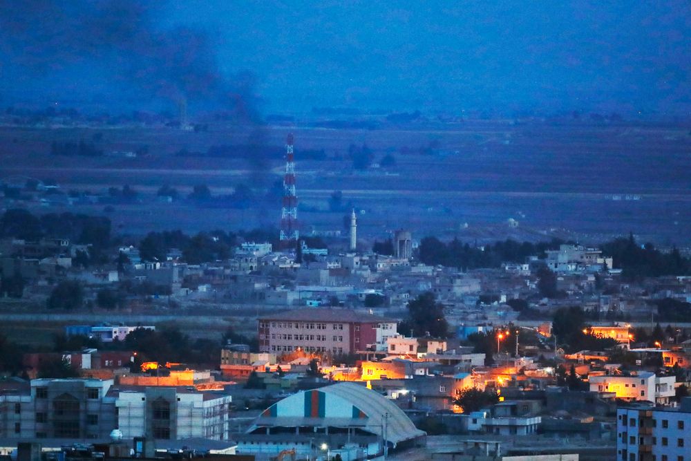 In this photo taken from the Turkish side of the border between Turkey and Syria, in Ceylanpinar, Sanliurfa province, southeastern Turkey, smoke billows from targets in Ras al-Ayn, Syria, caused by bombardment by Turkish forces, Tuesday, Oct. 15, 2019. Turkish artillery on Tuesday pounded suspected Syrian Kurdish positions near the town in northeast Syria amid reports that Kurdish fighters had retaken the town as Turkey pressed ahead with a military incursion that has drawn widespread condemnation. (AP Photo/Lefteris Pitarakis) In this photo taken from the Turkish side of the border between Turkey and Syria, in Ceylanpinar, Sanliurfa province, southeastern Turkey, smoke billows from targets in Ras al-Ayn, Syria, caused by bombardment by Turkish forces, Tuesday, Oct. 15, 2019. Turkish artillery on Tuesday pounded suspected Syrian Kurdish positions near the town in northeast Syria amid reports that Kurdish fighters had retaken the town as Turkey pressed ahead with a military incursion that has drawn widespread condemnation. (AP Photo/Lefteris Pitarakis)