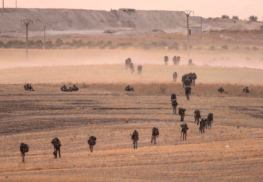 In this Monday, Oct.14, 2019 photo made available Tuesday, Oct. 15, 2019, Turkey's forces advance towards Manbij, Syria. U.S. military spokesman says U.S. forces have left Kurdish-held town of Manbij, part of withdrawal from northeast Syria. (Ugur Can/DHA via AP) In this Monday, Oct.14, 2019 photo made available Tuesday, Oct. 15, 2019, Turkey's forces advance towards Manbij, Syria. U.S. military spokesman says U.S. forces have left Kurdish-held town of Manbij, part of withdrawal from northeast Syria. (Ugur Can/DHA via AP)