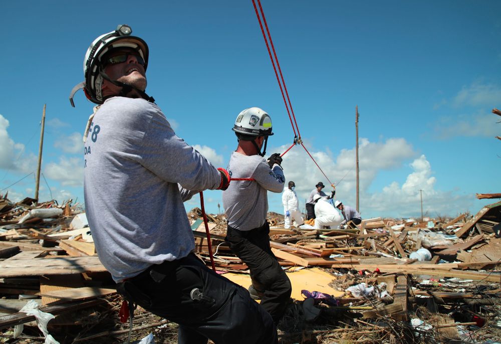 Members of the fire rescue team Task Force 8, from Gainesville, Florida, help remove a body one week after Hurricane Dorian hit The Mudd neighborhood in the Marsh Harbor area of Abaco Island, Bahamas, Monday, Sept. 9, 2019. Dorian, the most powerful hurricane in the northwestern Bahamas' recorded history, has killed at least 44 people in Bahamas as of Sunday, Sept. 8, according to the government. (AP Photo/Gonzalo Gaudenzi) Members of the fire rescue team Task Force 8, from Gainesville, Florida, help remove a body one week after Hurricane Dorian hit The Mudd neighborhood in the Marsh Harbor area of Abaco Island, Bahamas, Monday, Sept. 9, 2019. Dorian, the most powerful hurricane in the northwestern Bahamas' recorded history, has killed at least 44 people in Bahamas as of Sunday, Sept. 8, according to the government. (AP Photo/Gonzalo Gaudenzi)