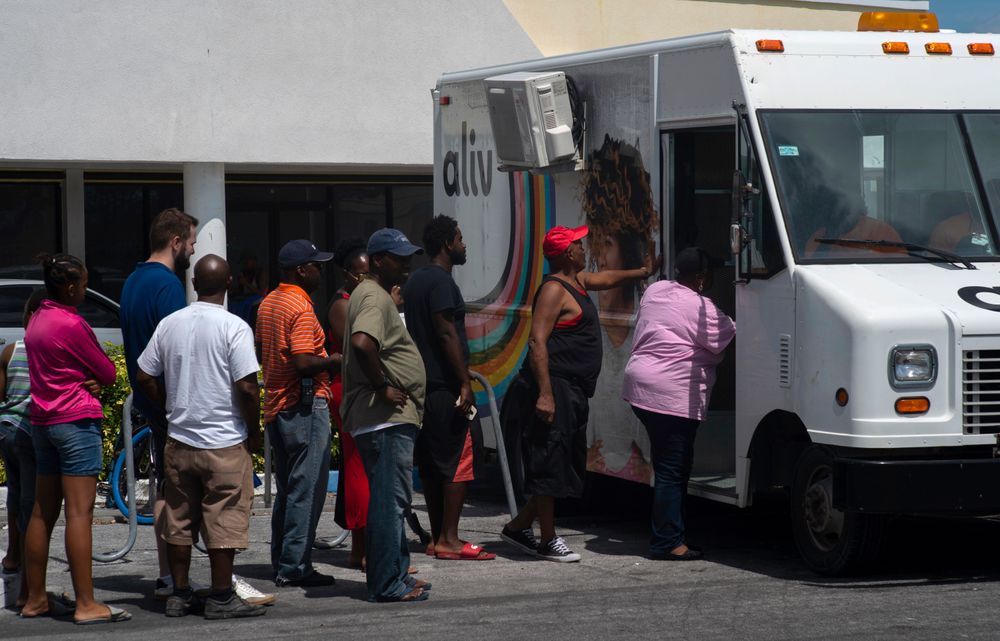 People line up to buy pre-paid cell phone cards, for sale from a mobile Aliv office, after the passing of Hurricane Dorian in Freeport, Bahamas, Wednesday, Sept. 11, 2019. While power has returned to much of Grand Bahama, spokesman Carl Smith for the country’s emergency management Agency said the electrical infrastructure around Marsh Harbour, Abaco’s largest city, was destroyed. (AP Photo/Ramon Espinosa) People line up to buy pre-paid cell phone cards, for sale from a mobile Aliv office, after the passing of Hurricane Dorian in Freeport, Bahamas, Wednesday, Sept. 11, 2019. While power has returned to much of Grand Bahama, spokesman Carl Smith for the country’s emergency management Agency said the electrical infrastructure around Marsh Harbour, Abaco’s largest city, was destroyed. (AP Photo/Ramon Espinosa)