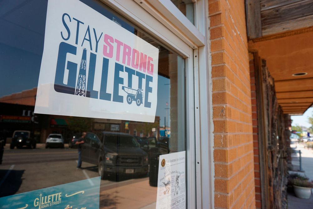 In this Thursday, Sept. 5, 2019 photo shows a poster urging locals to stay strong amid hardship in a Gillette, Wyo, storefront on the Eagle Butte mine just north of Gillette, Wyo. The shutdown of Blackjewel LLC's Belle Ayr and Eagle Butte mines in Wyoming since July 1, 2019 has added yet more uncertainty to the Powder River Basin's struggling coal economy. (AP Photo/Mead Gruver) In this Thursday, Sept. 5, 2019 photo shows a poster urging locals to stay strong amid hardship in a Gillette, Wyo, storefront on the Eagle Butte mine just north of Gillette, Wyo. The shutdown of Blackjewel LLC's Belle Ayr and Eagle Butte mines in Wyoming since July 1, 2019 has added yet more uncertainty to the Powder River Basin's struggling coal economy. (AP Photo/Mead Gruver)