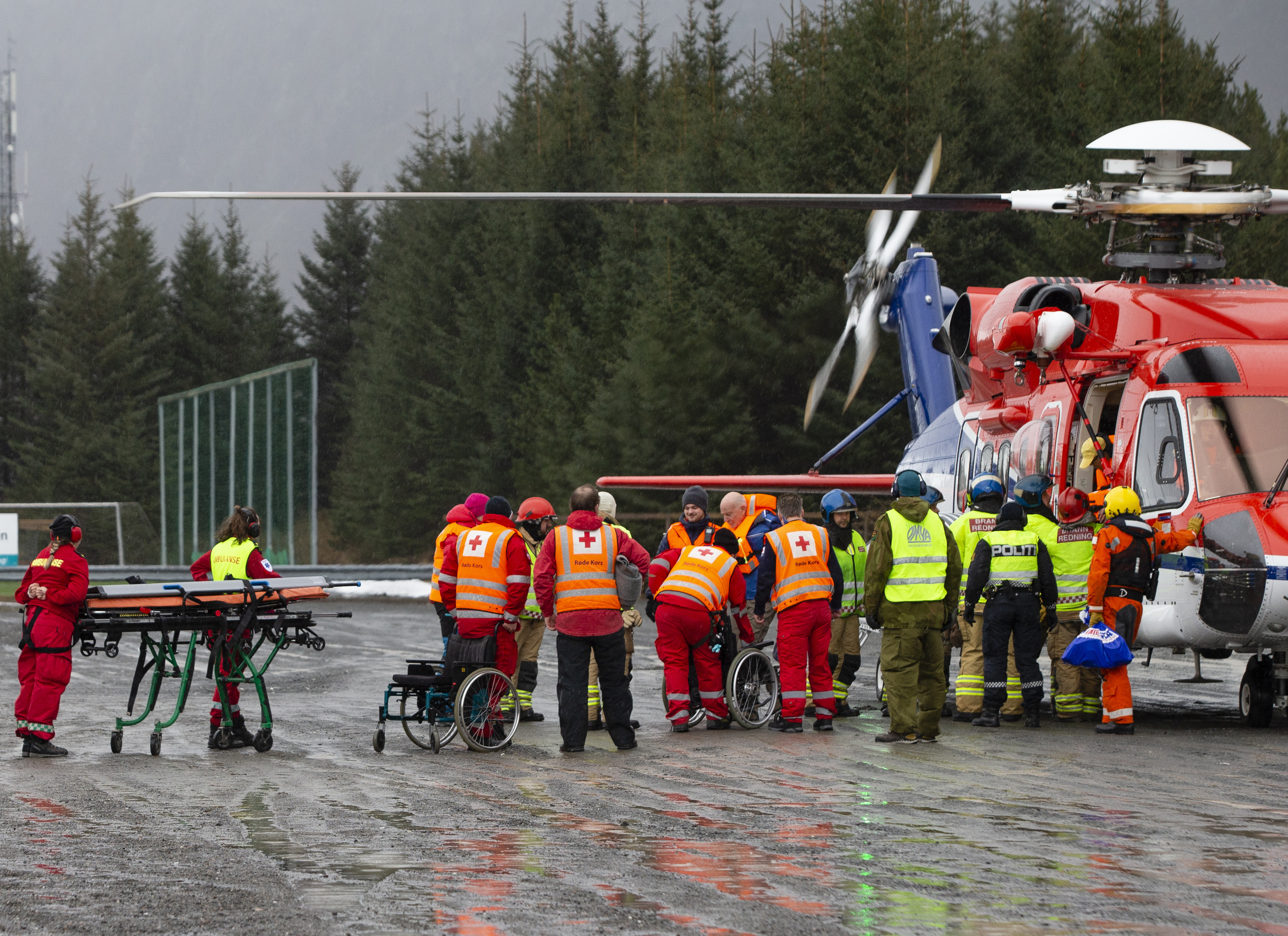 Passengers are helped from a rescue helicopter in Fraena, Norway, Sunday March 24, 2019, after being rescued from the Viking Sky cruise ship. Rescue workers are evacuating more passengers from a cruise ship that had engine problems in bad weather off Norway's western coast while authorities prepare to tow the vessel to a nearby port. (Svein Ove Ekornesvag/NTB Scanpix via AP) Passengers are helped from a rescue helicopter in Fraena, Norway, Sunday March 24, 2019, after being rescued from the Viking Sky cruise ship. Rescue workers are evacuating more passengers from a cruise ship that had engine problems in bad weather off Norway's western coast while authorities prepare to tow the vessel to a nearby port. (Svein Ove Ekornesvag/NTB Scanpix via AP)